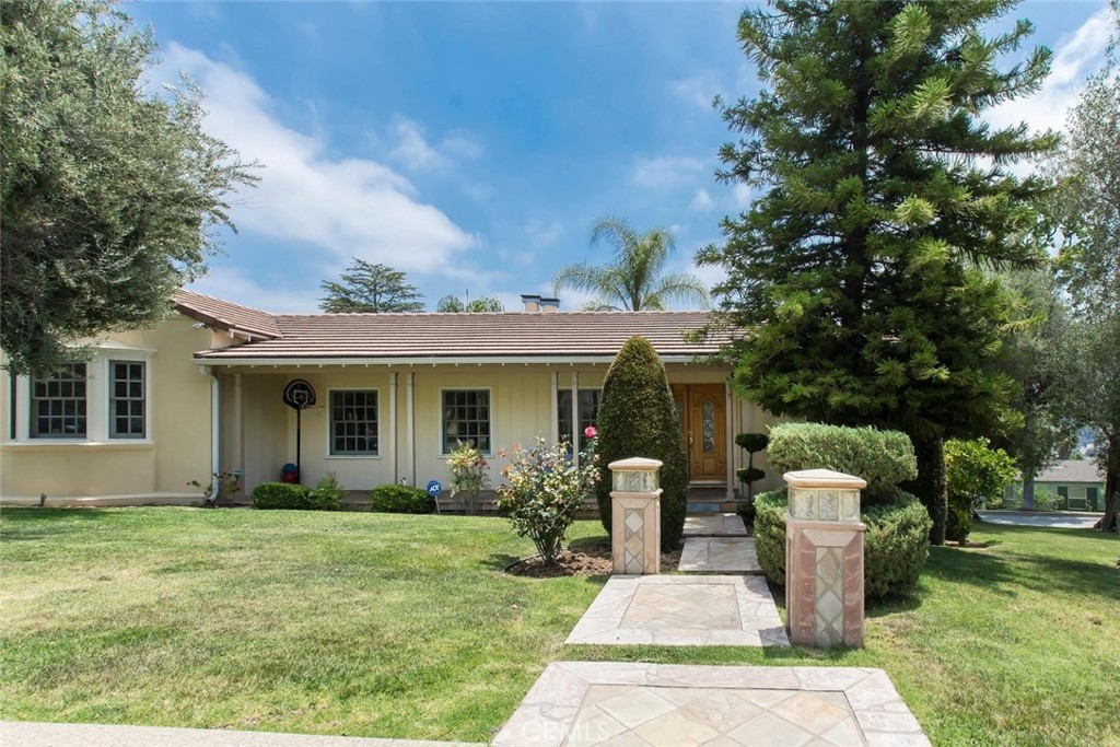 Live in the best of all worlds in the serene and prestigious Royal Canyon neighborhood. This beautifully maintained 3 bedroom 3 bathroom home for lease offers 2017 square feet of thoughtfully designed living space. A formal foyer welcomes you inside, setting the tone for the elegance and comfort found throughout. Inside, you will find a warm and inviting living room with a cozy fireplace, complemented by a separate family room ideal for relaxing or entertaining. The bright kitchen offers ample cabinet space, flowing seamlessly into a formal dining area perfect for gathering with loved ones. Natural light and recessed lighting fill every corner of the home, creating a bright and welcoming atmosphere. Each bedroom is generously sized, featuring walk in closets and en-suite or nearby bath access. French doors lead you outside to breathtaking canyon views, lush landscaping, and a peaceful waterfall, an entertainers dream with the perfect BBQ setup. A spacious 2 car garage provides added storage and convenience. Situated in a prime Glendale location, this home combines comfort, space, and tranquility in one of the city's most sought after communities.
