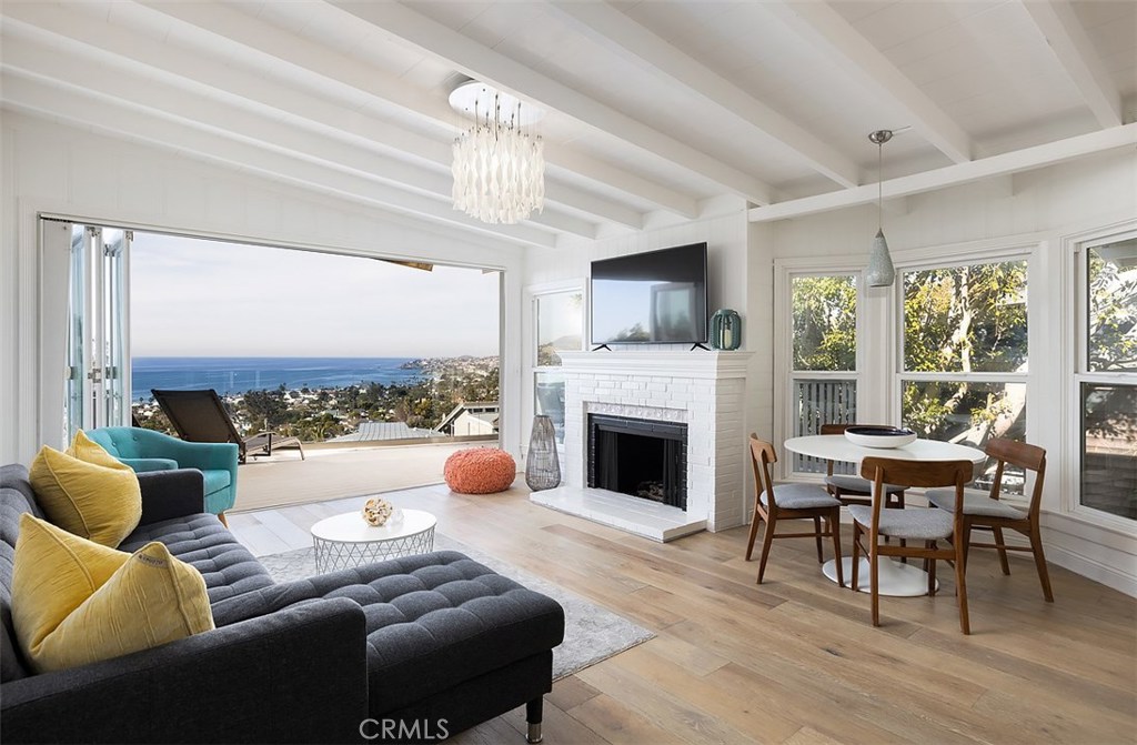 Breathtaking panoramic coastline views and Catalina sunsets from almost every room await you in this unfurnished 3 bedroom, 2 bathroom home. On the main level, enjoy sun-drenched indoor-outdoor living and dining with a large deck, spacious living room with a fireplace and new hardwood flooring, dining area and a gourmet kitchen with a Bertazzoni range. Also on the main level is a good sized bedroom that opens onto a large tree-covered deck, a beautifully remodeled bathroom, and another bedroom which includes a private deck with dramatic ocean views. The lower level, where the main entrance is located, includes a large master suite, complete with fireplace, panoramic ocean views, a gorgeously remodeled bathroom and an oversized walk-in closet, also with ocean views and large enough for use as a home office. A spacious laundry and linens room is located on the lower level as well. Parking is easy with a two-car garage space, plus street and driveway space for at least three more. Ideally situated on a street-to-street lot, perched just above the best Laguna Beach has to offer - spectacular beaches, renowned art galleries, restaurants, shopping, Bluebird Park, plus acclaimed hiking and biking trails. Make this your time to experience the true Laguna Beach lifestyle.