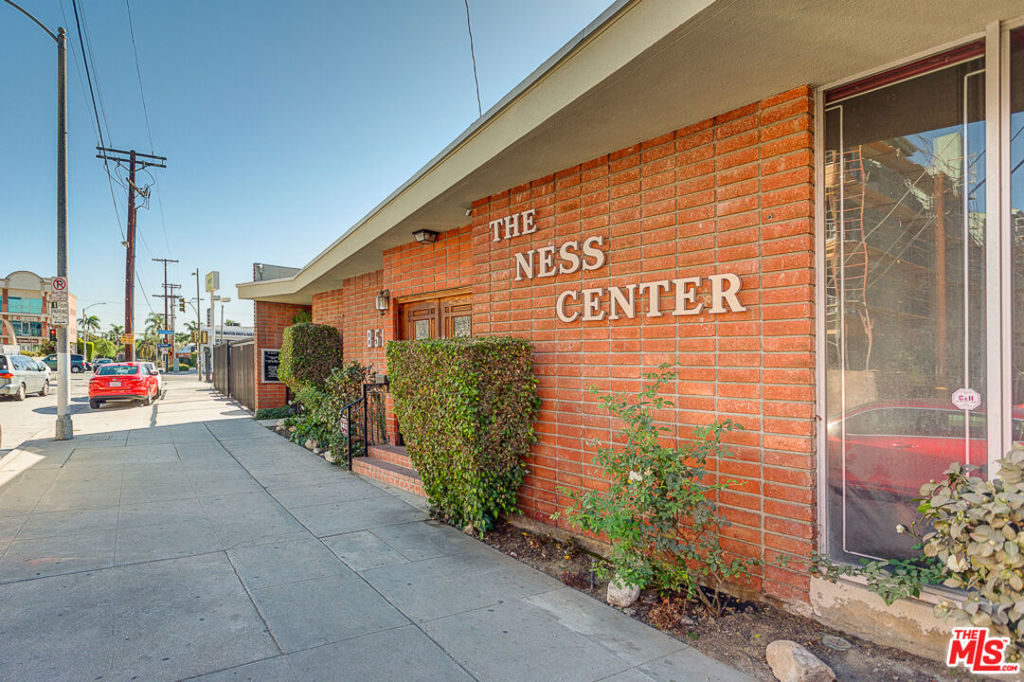 Discover an exceptional commercial space in a stunning, light-filled single-story building. This versatile property features 14 offices, including 3 executive offices with private entrances. One executive office is double-sized and includes an attached assistant office. The east side boasts 8 offices with floor-to-ceiling windows overlooking a private landscaped courtyard and access to the private entrances. The space includes a spacious 15-foot conference room and a 25x15 foot flex space, perfect for meetings and events. Every office is equipped with windows, and the building offers 6 storage/supply closets, a formal reception area, a central lobby, and a separate rear entry, ensuring maximum flexibility. Four half baths, two at each end of the building, complete the layout. With new paint, flooring, and exposing the 12-foot ceilings, this space will truly shine. The layout can be easily reconfigured to accommodate up to 4 private units with their own entrances and bathrooms. While there is no dedicated parking, ample street parking is available, and nearby covered parking may be available for rent. This property is unmatched at its price point, especially in this area. Located diagonally from the Marsel Retail Plaza at La Cienega & Whitworth and the proposed 1050 La Cienega Tower with 500+ retail & residential units, you can set up shop for a fraction of future costs. Combine this with the 9,148 sqft lot available next door, you get instant value with a 16,000 sqft corner lot measuring approximately 16,000 perfect for a major development.