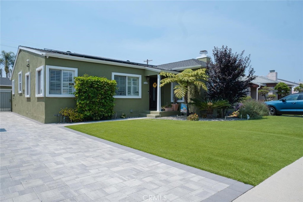 Discover One of Leimert Park’s Best-Kept Secrets! Welcome to this beautifully maintained 3-bedroom, 3-bathroom home nestled in the highly sought-after Tom Bradley Square enclave of Leimert Park. Combining charm, space, and modern upgrades, this home is perfect for comfortable living and entertaining. The front yard features low-maintenance drought-tolerant landscaping, and a paved driveway that easily accommodates up to five vehicles.
Step into a warm and inviting living space with gleaming hardwood floors, plantation shutters, recessed lighting, crown molding, baseboards, and a cozy wood-burning fireplace. Central heating and air conditioning ensure year-round comfort. Adjacent to the living room, the formal dining area showcases rich maple-stained hardwood flooring and recessed lighting—ideal for hosting dinner parties or family meals. The bright and spacious kitchen boasts 24” x 24” tile flooring, ample cabinetry, and plenty of counter space for all your culinary needs. Just off the kitchen is a sunny laundry room with additional storage. Retreat to the expansive primary bedroom featuring central air, recessed lighting, ceiling fan, and shuttered windows. The en-suite bathroom includes a Jacuzzi soaking tub. A soft lavender accent wall adds a peaceful touch, and there’s also a separate walking clothes closet for added convenience. The second Bedroom is currently used as a home office, this bedroom features hardwood floors, a ceiling fan, recessed lighting, shuttered windows, and central heat and air. Third bedroom is light, bright, and airy, which also includes hardwood flooring, recessed lighting, and a ceiling fan perfect for guests or family members. Enjoy gatherings and quiet moments in the private backyard, designed for entertaining. It includes a paver patio area, concrete block privacy fence. A detached two-car garage provides additional storage with a separate storage room. Additional home features include solar panel on the roof. Don’t miss your opportunity to own this hidden gem in the heart of Leimert Park!