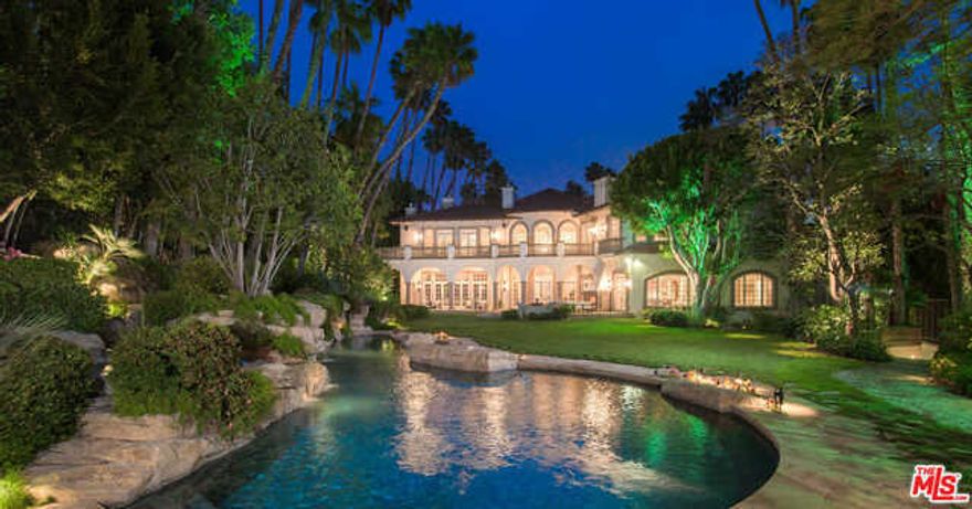 Tucked behind gates in the coveted Platinum Triangle, this magnificent Mediterranean estate, set on over &#195;&#8218;&#194;&#190; an acre in lower Bel Air, showcases opulent interiors and resort-like grounds. Beyond a wraparound motor court, grand-scale living spaces include a soaring foyer, great room, elegant parlor and restaurant-caliber bar. A light-filled dining room is situated off the chef's kitchen. Upstairs, 2 exceptional master suites showcase fireplaces and sweeping balconies overlooking lush grounds. Additionally, there are 4 bedrooms (including maid's quarters) on the main level, plus an elevator serving all 3 floors, including the auto gallery. Outside, an expansive loggia flows to a sprawling, backyard surrounded by mature trees. Situated off an incredible pool with water features and tropical landscaping, a two-story guest house offers 1,000 SF of living space. This home is a showpiece of unbridled elegance in one of the country's most esteemed neighborhoods, moments from the Bel Air Hote
