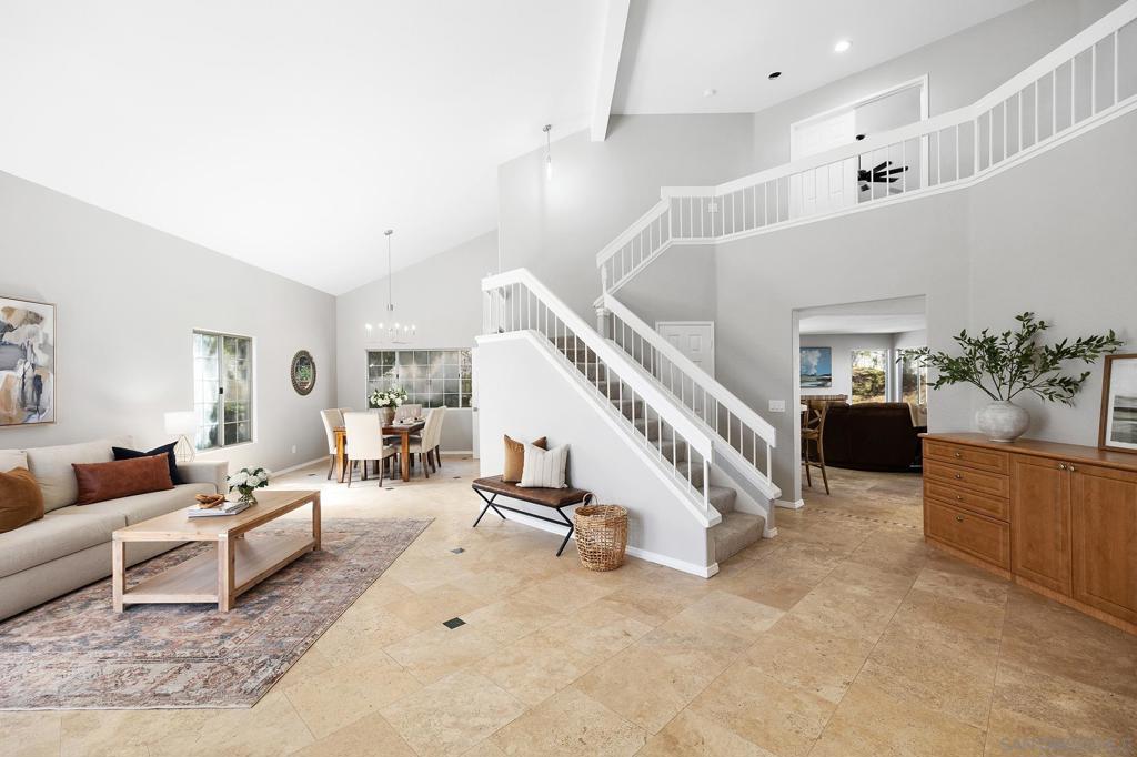 Welcome to your dream home in the heart of Poway! This upgraded 4BR/3BA, 3-car garage home offers 2,736 sq. ft. of living space with a pool, RV parking, and owned solar. From the moment you step inside, you’ll be greeted by bright, open interiors, attractive finishes, and a layout that blends coziness and sophistication. The downstairs main level features travertine tile, a full bedroom and bath with Murphy bed and built-in closet, and separate living, dining, and family rooms. The remodeled kitchen includes new cabinets, granite counters, JennAir and KitchenAid stainless steel appliances, farmhouse basin sink, pantry cabinet, spice rack, and functional storage. The whole house water filter ensures fresh water throughout. Upstairs, the primary suite boasts a walk-in closet and a fully remodeled spa-like bath with new cabinets, granite counters, retiled surround, step-in shower with bench and dual shower heads and pocket door. Outside, enjoy the sparkling pool, lemon tree, newer stucco, vinyl fencing, fenced and irrigated yard, new patio pergolla plus side RV parking. Located near top-rated Poway schools, shopping, and dining, this move-in ready home is a true gem providing you with plenty of options for entertaining and everyday living.