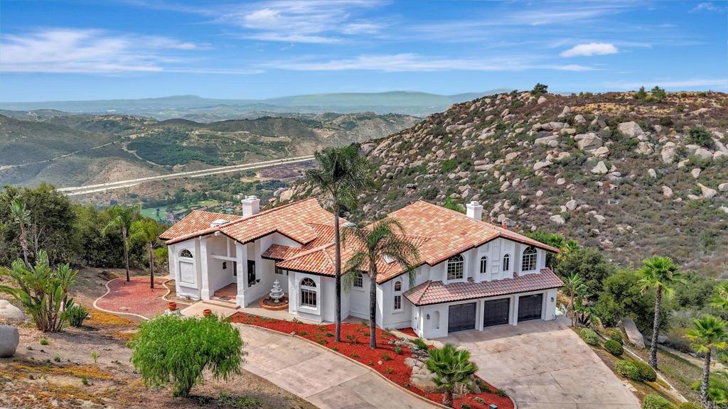 Discover refined living in this stunning 4-bedroom, 5-bathroom home located in the prestigious, gated Rimrock community. Spanning 4,788 square feet, this beautifully designed estate offers privacy and comfort with each bedroom featuring its own en-suite bathroom. Enjoy cooking and entertaining in the gourmet chef’s kitchen, complete with high-end appliances, custom cabinetry, and a spacious layout that flows seamlessly into the main living areas. Soak in the extraordinary panoramic views from nearly every room — and on a clear day, catch a glimpse of the sparkling Pacific Ocean. A spacious 3-car garage and luxurious finishes throughout complete this remarkable home. Experience elevated living in one of North County San Diego’s most sought-after communities.