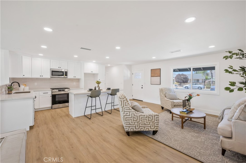 Welcome to 28630 Carmel Rd, a fully renovated 3-bedroom, 2-bath home located in the desirable Sun City Civic Association 55+ community. Designed with comfort and connection in mind, this home features a spacious open-concept floor plan where the living room, dining area, and modern kitchen flow seamlessly together. The kitchen shines with bright white shaker cabinetry, quartz countertops, porcelain tile backsplash, and a large island perfect for casual dining or entertaining. Luxury vinyl plank flooring and recessed lighting throughout the main living areas create a bright, inviting atmosphere. Both bathrooms have been stylishly updated, one with a custom walk-in shower accented by gold finishes, the other with a serene tub surround in soothing green tile. The primary suite offers a peaceful retreat with views of the low-maintenance yard. Peace of mind comes with a brand-new roof, ensuring years of worry-free living. As part of the Sun City Civic community, residents enjoy access to pools, a spa, fitness center, clubhouse, game rooms, and a full calendar of social activities and events. The neighborhood is also conveniently located near shopping, dining, golf courses, and freeway access. This move-in ready home is the perfect blend of modern upgrades and an active, community-centered lifestyle.