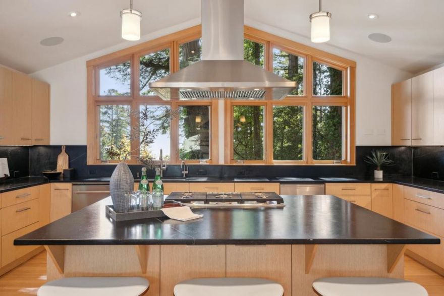 Experience the ultimate retreat, where majestic redwoods, sweeping canyon vistas, and ocean views provide a stunning backdrop for everyday living. This 3,323 sq ft custom home features 5 bedrooms and 3.5 bathrooms. The main level boasts soaring ceilings, expansive windows, and skylights that flood the space with natural light, highlighting the breathtaking scenery. The open-concept design connects the spacious living area to the kitchen, featuring Brazilian soapstone countertops, rich wood flooring, and stainless steel appliances, perfect for entertaining or relaxing. An adjoining family room offers more space to unwind. Head downstairs to access the expansive deck, versatile bedrooms, and flexible spaces. Outdoor living takes center stage as you step onto the oversized deck, soak in the hot tub under a canopy of stars, or explore the meticulously terraced yard, offering space to garden, relax, or let your animals roam free. Ideally located, a short walk to miles of open space trails,10 minutes to Hwy 280 with easy access to SFO, Silicon Valley, and the Half Moon Bay coast, this home offers the perfect blend of serenity and convenience. Come experience the lifestyle you've been dreaming of, surrounded by nature, tranquility, and the welcoming community of Kings Mountain.