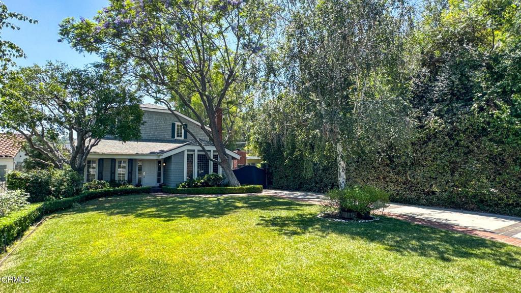 Tucked away on one of southwest Pasadena's most desirable streets, this traditional pool home with 4 bedrooms and 3 baths offers fantastic curb appeal on a tree-lined street with a convenient bedroom and bath on the main floor. The front entry welcomes you to a desirable floorplan with a beautifully appointed living room with fireplace, a formal dining room, spacious family room with wet bar, and an updated kitchen with center island and all appliances. Wood and tile floors flow throughout the home, and central air conditioning ensures year-round comfort. French doors in the family room lead to an outdoor deck perfect for BBQing and enjoying the California weather, while sliding glass doors from the kitchen lead to a balcony with tree-top views. Relax in the master bedroom suite with vaulted ceiling, large walk-in closet with built-ins, and a spa-like bath with double sinks, separate tub, and a steam shower. On the lower level, unwind in the spectacular den/game room or work in the private office with separate entrance and direct access to the 2-car garage. Additional off-street parking adds convenience, and lush landscaping provides privacy and a serene backdrop. The outdoor resort-style backyard features a sparkling pool and spa along with manicured gardens. Down the street from San Rafael Elementary School and close to San Rafael Park with easy access to major highways for a smooth commute to employment hubs, shopping, dining, and recreation destinations.