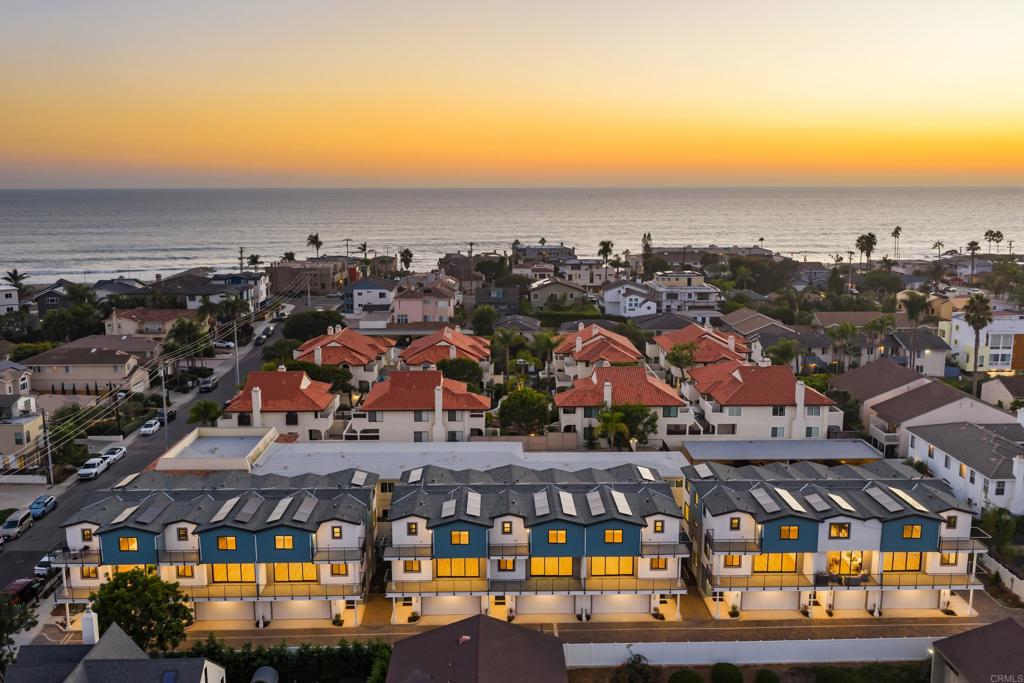 NEW construction, 2 blocks to Tamarack Beach! Experience coastal luxury at The Currents—a brand-new enclave of nine modern townhomes just steps from Carlsbad’s sunlit Tamarack Beach. Nestled on Chinquapin Avenue, this exclusive community seamlessly blends contemporary design with timeless seaside charm. 322 Chinquapin is a corner-unit residence set down a private driveway offering 4 bedrooms, 3.5 baths, and 2,265 sq. ft. of thoughtfully crafted living space. Designed for effortless indoor-outdoor living, the home features a private fenced yard, two breezy decks, and an open-concept layout that invites natural light throughout. High-end finishes define the interiors: a chef’s kitchen with Wolf and SubZero appliances, quartz countertops, and an oversized island; stylish LVP flooring; designer-selected tile, lighting, and hardware; plus Delta and Kohler plumbing fixtures. The great room extends seamlessly to a deck via stacking Western doors, while the primary suite offers a spa-like bath, expansive walk-in closet, and private deck retreat. Additional highlights include a first-floor guest suite, third-floor laundry, abundant storage, and an attached two-car garage finished with epoxy floor. Smart, sustainable features—owned solar and integrated home technology—enhance convenience and efficiency. Outdoors, the fenced yard is complete with a paver patio and low-maintenance turf. Ideally situated two blocks from Tamarack Beach, steps from the Agua Hedionda Lagoon, and within walking distance to downtown Carlsbad Village, The Currents offers an unparalleled lifestyle. From morning runs along the coastline to sunset strolls through the Village, this is more than a home—it’s your gateway to coastal adventure and laid-back luxury living. Photos and video tour are of the model home, interior finishes and floor plan are the same.