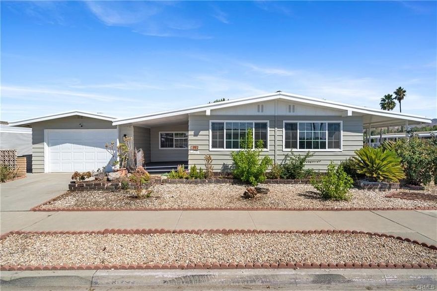 Welcome to this beautifully updated home located in the 55+ community of Sierra Dawn Estates in Hemet, CA. This spacious 2-bedroom, 2-bathroom manufactured home offers 1,440 sq-ft of comfortable living space on a large corner lot and best of all, you own the land with no space rent! Move-in ready and fully renovated, this property features a bright and open layout with a large living room, spacious recreation room, and a beautifully upgraded kitchen complete with new self-closing cabinets, quartz countertops, new stainless steel sink and faucet, built-in microwave, and brand-new appliances. Fresh interior and exterior paint, new dual-pane windows, recessed lighting, updated light fixtures, and a new roof add to the home’s modern appeal. The primary suite offers two walk-in closets, while both bathrooms provide comfort and function. Enjoy the outdoors on the cozy covered patio with decking, and take advantage of the fully fenced lot with a separate large storage structure—perfect for hobbies, tools, or extra storage. Additional highlights include a 1-car garage, low taxes, and a low HOA with access to community amenities. Conveniently located near shopping centers, dining, parks, and medical facilities, this home combines affordability, lifestyle, and comfort in one of Hemet’s most established senior communities. Don't miss this incredible opportunity.