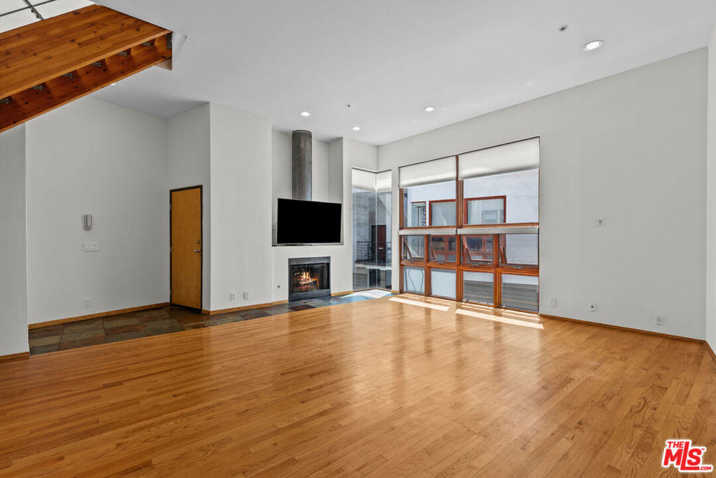 Just half a block from the vibrant shops, restaurants, and cafes of Rose Avenue, this striking architectural townhome offers the ultimate in Venice beach living. With a spacious and versatile open floor plan, this home is ideal for entertaining, creative live/work setups, or simply enjoying the coastal lifestyle. The main level boasts soaring ceilings, oversized windows, a fireplace, and an open-concept kitchen, living area, powder room, and dedicated workspace. Upstairs, you'll find two generous primary suites, each with its own private bathroom, providing comfort and privacy. Enter to the easily accessible rooftop deck perfect for morning coffee or sunset Happy Hour. Thoughtfully designed with high-end natural materials including concrete, slate, and hardwood floors. The lower level offers a large, direct-access two-car garage with ample storage and in-unit laundry. Additional secured parking and guest spots are available on-site. Unbeatable location just moments to Rose Ave, Abbot Kinney, Main Street, the beach, Whole Foods, and more.
