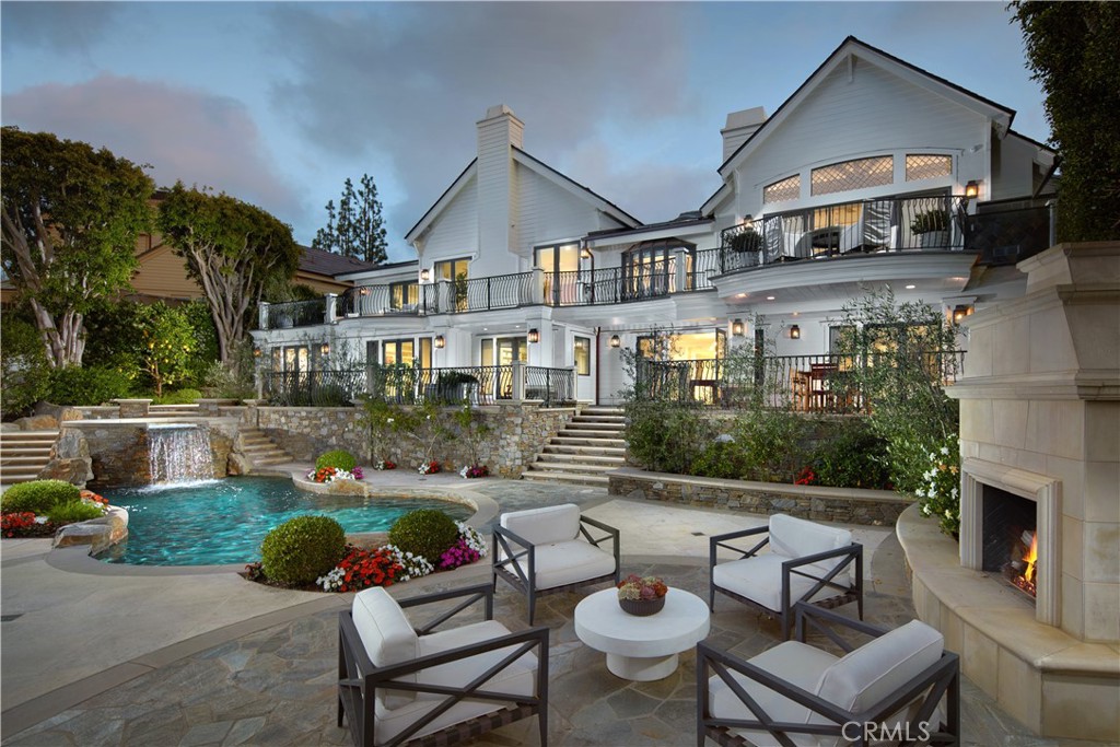 Gracefully perched along the iconic 15th hole in the heart of Newport Beach’s exclusive guard-gated community of Big Canyon, this masterfully reimagined estate captures front-row fairway views and the serene beauty of a striking par-3 played over water. A true architectural showpiece, the home was taken down to the studs and transformed by the renowned Amber Interiors, blending bespoke finishes with timeless California elegance.
Inside, rich walnut floors, custom millwork, designer lighting, and hand-selected wallpapers create a layered, textural experience that feels both refined and warmly livable. The interiors evoke a curated calm—where organic materials, soft architectural lines, and thoughtful craftsmanship create an ambiance that is both elevated and inviting.
Designed for modern living, the home is powered by solar energy and enhanced with integrated smart home features including Control4 automation, surround sound, video surveillance, and more. Outside, a resort-inspired backyard features a PebbleTec saltwater pool, lush landscaping, and multiple entertaining spaces, making large-scale gatherings effortless.
Upstairs, the sun-drenched primary suite offers a tranquil escape with sweeping fairway views, luxurious finishes, dual closets, and a spa-like bathroom retreat that provides peaceful seclusion.
Homes of this caliber are rare—crafted with premium materials, top-tier construction, and a level of customization that would be extraordinarily costly to replicate today. From the quality of the build to the attention to detail, this estate represents a standard that truly stands apart.
Just moments from Fashion Island, Newport Harbor, world-class beaches, and top-tier schools, this exceptional residence offers not just a home, but a lifestyle of design, ease, and distinction—set within one of Orange County’s most prestigious communities.