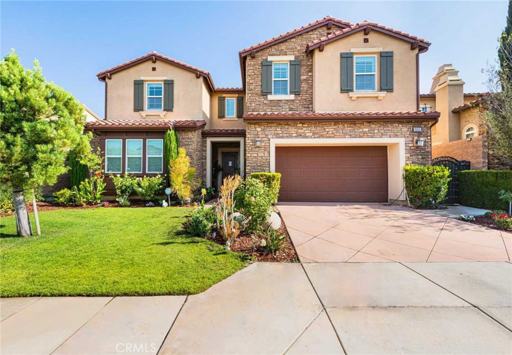 Absolutely stunning and well-maintained former Toll Brothers model home located in the Amalfi Hills community. A grand two-story foyer opens to an elegant family room with fireplace and a spacious great room, seamlessly connecting to the upgraded gourmet kitchen with two oversized center islands. The formal dining area leads to a backyard designed for gatherings, featuring a custom patio, outdoor fireplace, built-in BBQ, and granite counter. The main level includes a private guest suite and powder room, while a curved staircase leads to a versatile loft with balcony and serene backyard views. The expansive primary suite offers dual walk-in closets and a spa-inspired bath with soaking tub and separate shower. Three additional upstairs bedrooms and a laundry room provide ample space. Additional features include a three-car tandem garage, surround sound system, water softener, hot & cold water purifier, low HOA fees, and no Mello Roos. Conveniently located near shopping, Yorba Linda High, and the Yorba Linda Town Center.