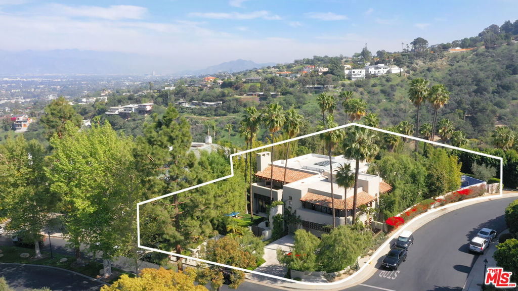 Masterpiece Villa situated in the highly esteemed enclave of Mulholland Estates.Experience a world of luxury and privacy guarded by 24 hour security. This stunning home features 7,407 SQFT of living space with 5 bedrooms, 7 bathrooms on over a half-acre flat lot, offering serenity while providing unmatched amenities for entertaining as well. The grand, 2-story timeless floor plan offers light-filled entry, high ceilings, a formal inviting living room w/fireplace & bar and casual living room with sliding door to the private yard. Wood paneled library, spacious media/family room with fireplace and sliding doors that open to patio.Formal Dining room, gourmet kitchen with center island. Expansive outdoor area, resort-style private yard, patio, pool & Sports Court, BBQ & outdoor shower. Upstairs, the majestic master bedroom suite showcases two oversized terraces and master bath with walk-in closets. 3 additional bedroom suites with walk-in closets are in close proximity. Maid's room & laundry room also available on the 1st floor. Don't miss your chance to enjoy California living at its finest. Tenant occupied until August 31, 2022 at the rate of $31,000/month. HOA amenities include: 3 Tennis Courts w/Basketball Court, 24 hours guard, Recreation Room, community landscaping and maintenance.