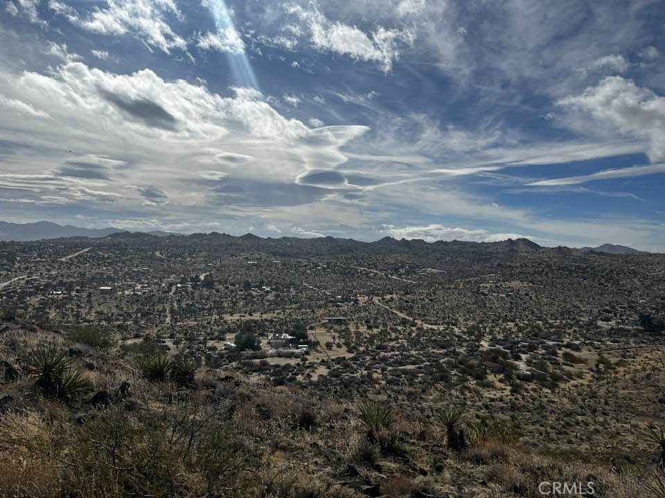 Not sure if you will ever see another property like this again, perched atop a mountain top, offering unparalleled desert views that will leave you breathless. A paved road from the bottom of the Mountain will take you to the top of this hidden gem, where the promise of your dream home awaits. Pictures do not do this lot justice, you need to see it in person to understand.
Picture yourself surrounded by true 360-degree views that you will not find on any other property around it, a visual symphony of nature's beauty in every direction. This includes Joshua tree, Pioneertown and Palm Springs. The property boasts a main water line and convenient electric poles close, ensuring your comfort and connectivity.(Buyers to verify all utilities)
A locked privacy gate at the base of the mountain adds exclusivity along with a paved road that effortlessly guides you to the top of this elevated sanctuary. Stand on this land, and you'll find that words fall short in capturing the profound feeling it evokes.
Seize the opportunity to own a piece of this unique landscape – a mountain retreat like no other in the area. Take a drive, gaze upon the majestic mountain, and envision your future home in this unparalleled setting. Your desert paradise awaits – see it for yourself today!
Video https://galleries.page.link/jqBPn