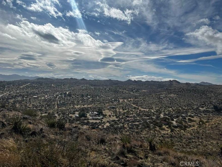 Not sure if you will ever see another property like this again, perched atop a mountain top, offering unparalleled desert views that will leave you breathless. A paved road from the bottom of the Mountain will take you to the top of this hidden gem, where the promise of your dream home awaits. Pictures do not do this lot justice, you need to see it in person to understand.

Picture yourself surrounded by true 360-degree views that you will not find on any other property around it, a visual symphony of nature's beauty in every direction. This includes Joshua tree, Pioneertown and Palm Springs. The property boasts a main water line and convenient electric poles close, ensuring your comfort and connectivity.(Buyers to verify all utilities)

A locked privacy gate at the base of the mountain adds exclusivity along with a paved road that effortlessly guides you to the top of this elevated sanctuary. Stand on this land, and you'll find that words fall short in capturing the profound feeling it evokes.

Seize the opportunity to own a piece of this unique landscape – a mountain retreat like no other in the area. Take a drive, gaze upon the majestic mountain, and envision your future home in this unparalleled setting. Your desert paradise awaits – see it for yourself today!

Video https://galleries.page.link/jqBPn