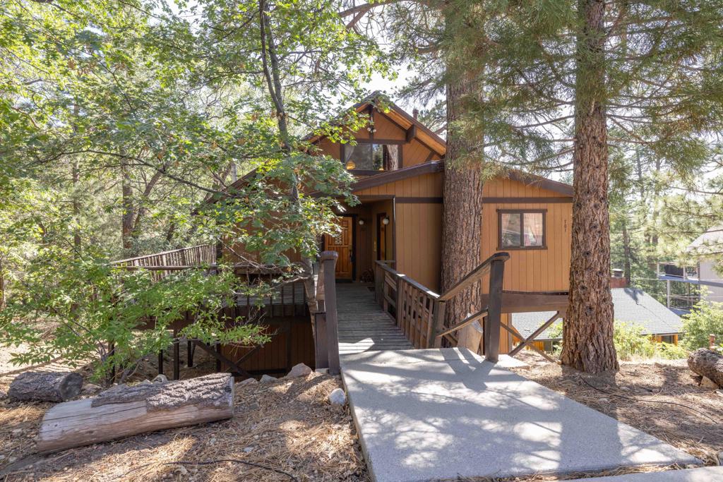 Nestled among the trees, this charming two-bedroom, two-bathroom home offers 1,832 square feet of inviting living space. The desirable reverse floorplan brings the main living area upstairs, creating a true ''treehouse'' feel--perfect for relaxing or entertaining with a view. A large loft adds flexibility, whether you're looking for a home office, guest space, or cozy den. The loft currently has a pool table, which is included in the sale. Plenty of windows throughout the home flood the space with natural light, making every room feel bright and airy. There is an extra room for storage off of the front porch. Surrounded by nature, this unique home combines comfort, functionality, and serene surroundings.