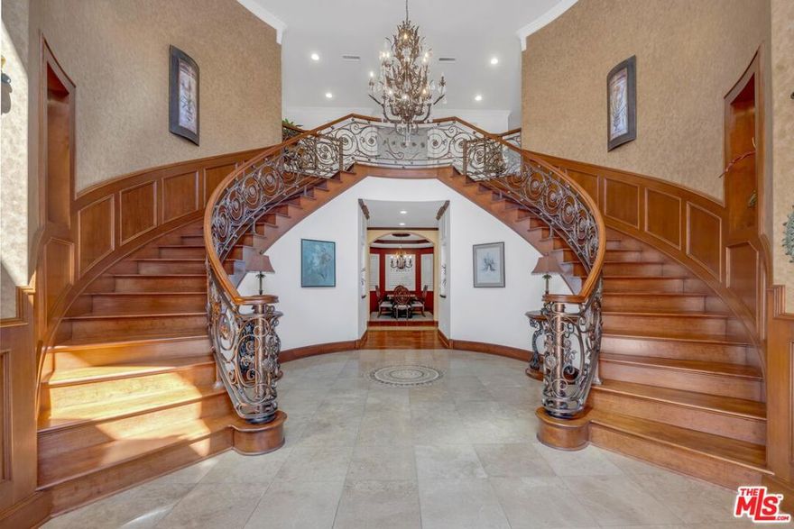 MOVE-IN-READY CONVENIENCE; FURNITURE IS ALSO NEGOTIABLE.  Discover unparalleled luxury in this stunning, privately-gated Mediterranean masterpiece, nestled in the prestigious Sutton Estates neighborhood of the Sherman Oaks flats. Set back 70 feet from the street, this exceptional compound offers 9,050 square feet of refined living space, blending grand elegance with effortless comfort. Entertain with ease in the expansive chef's kitchen, featuring dual dishwashers and seamless flow into the family room and resort-style backyard. Indulge in cinematic experiences within the gorgeous, dedicated theater/screening room, complete with a wet bar. The main residence boasts 5 luxurious bedrooms and an executive office, ensuring ample space for family and work. A detached guest house provides a private retreat, featuring a full bedroom, living area, kitchen, and walk-in closet. Beyond, is a "Casita" studio offering a versatile space for a gym, office, maids quarters or creative studio, complete with a 3/4 bath, laundry, and walk-in closet. The sprawling, over half-acre grounds are a haven of tranquility, showcasing meticulously landscaped gardens and mature trees. The resort-style backyard is an entertainer's dream, featuring an outdoor kitchen, BBQ, dual gas and wood-burning fireplace with a beamed trellis ceiling.  A motor court accommodates 10+ vehicles, alongside a 4-car garage. This landmark property presents a rare opportunity to own a slice of Sherman Oaks paradise. Ideal for extended families, car enthusiasts, or those seeking an extraordinary private retreat, this compound offers a lifestyle of unparalleled luxury and convenience. Schedule your private showing today and experience the grandeur firsthand.