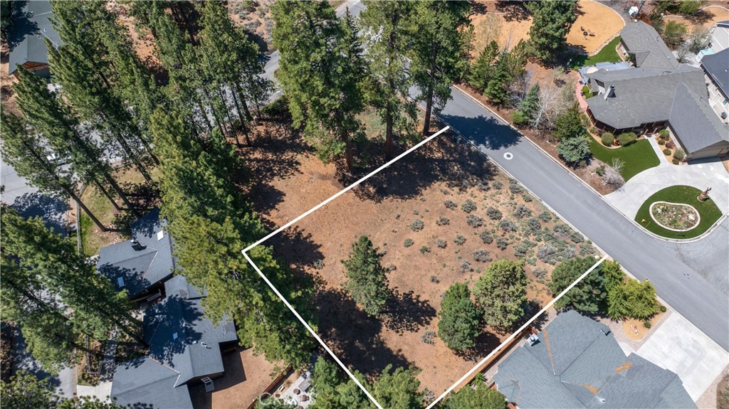 Seize a rare opportunity to own a piece of paradise in the prestigious Eagle Point Estates, one of Big Bear Lake's most coveted neighborhoods. This exceptional large, flat lot is the ideal foundation for building your dream home, complete with exclusive boat dock access to the shimmering waters of Big Bear Lake. Imagine the joy of designing your own custom mountain home, perfectly tailored to meet all your needs and desires, set amidst a community renowned for its tranquility and scenic beauty.
The property offers underground utilities, ensuring unobstructed views and a pristine landscape. Enjoy community amenities such as a private tennis court, a beach, and a park with a playground and picnic areas, all within a short stroll from your dock. This lot's prime location also boasts convenient proximity to all the attractions and activities Big Bear has to offer, making it a superb choice for those seeking a vibrant and luxurious mountain lifestyle. With very few lots remaining in this sought-after area, this is an opportunity you don't want to miss. No address has been assigned for this property