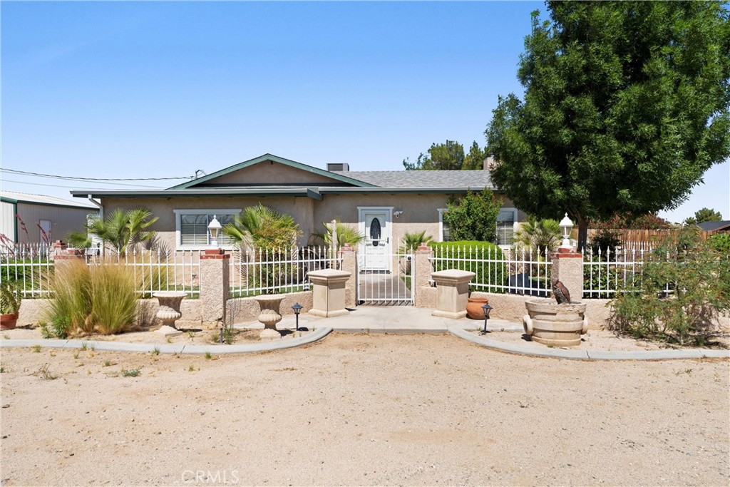 Rare Opportunity on this Vintage Custom Home with Pride of Ownership throughout located on 1.37 acres Zoned Light Industrial over looking SR14. This 3 bedroom, 2.5 bathroom this home features an open kitchen with large breakfast bar open to the great room with floor to ceiling custom stone fireplace with used brick hearth. Open beam tonged and grove ceilings giving this home a rustic cozy vibe. The primary suite and bath with walk-in closet, dual vanities, large soaking tub and separate shower. All other bedrooms are ample size. This home is an entertainer's delight with a huge patio and separate game room with a built-in bar and refrigerator, multiple TV's, slate top billiard and ping pong table all included in sale. There is a 12 x 60 Mobile Home included in sale which is a 2 bedroom, 1.5 bathrooms which comes with a separate title and included in sale . There is also a 30 x 30 detached garage, and full RV hook ups.