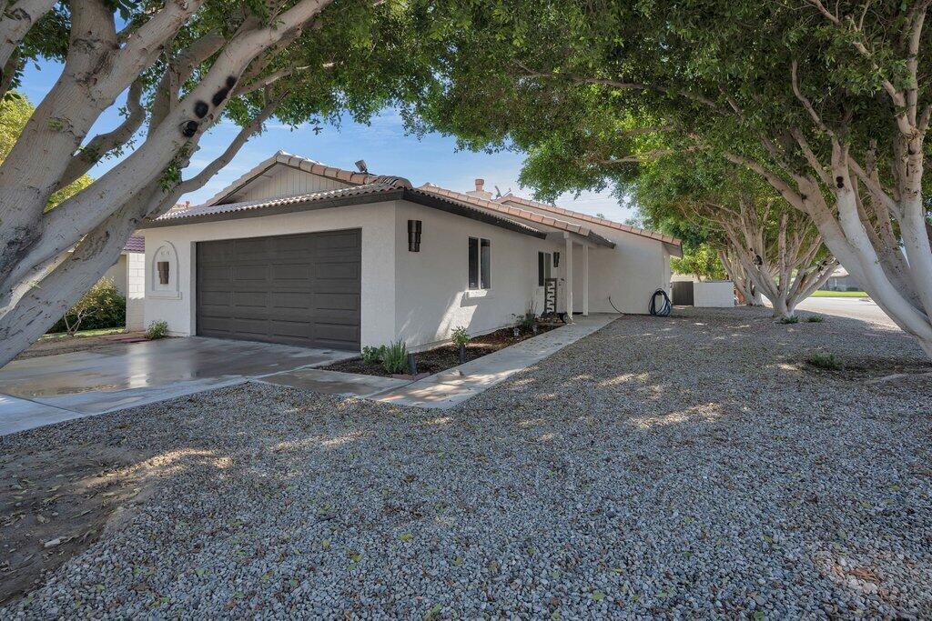 Nestled in the highly sought-after La Quinta Cove, this beautifully remodeled 4-bedroom, 2-bathroom home offers modern comfort with timeless charm. Situated on a corner lot and adorn with mature trees this home awaits it's new owners. Step inside to find an open floor plan with a bright and airy living space, perfect for entertaining or relaxing. The gourmet kitchen boasts sleek countertops, stainless steel appliances, and ample storage, making meal prep a breeze. Each bedroom is spacious and inviting, while the updated bathrooms feature stylish finishes. Outside, enjoy stunning mountain views and a low-maintenance yard ideal for desert living. Located just minutes from hiking trails, Old Town La Quinta, and top-rated schools, this home is a must-see for those seeking the perfect blend of quality upgrades and convenience.'