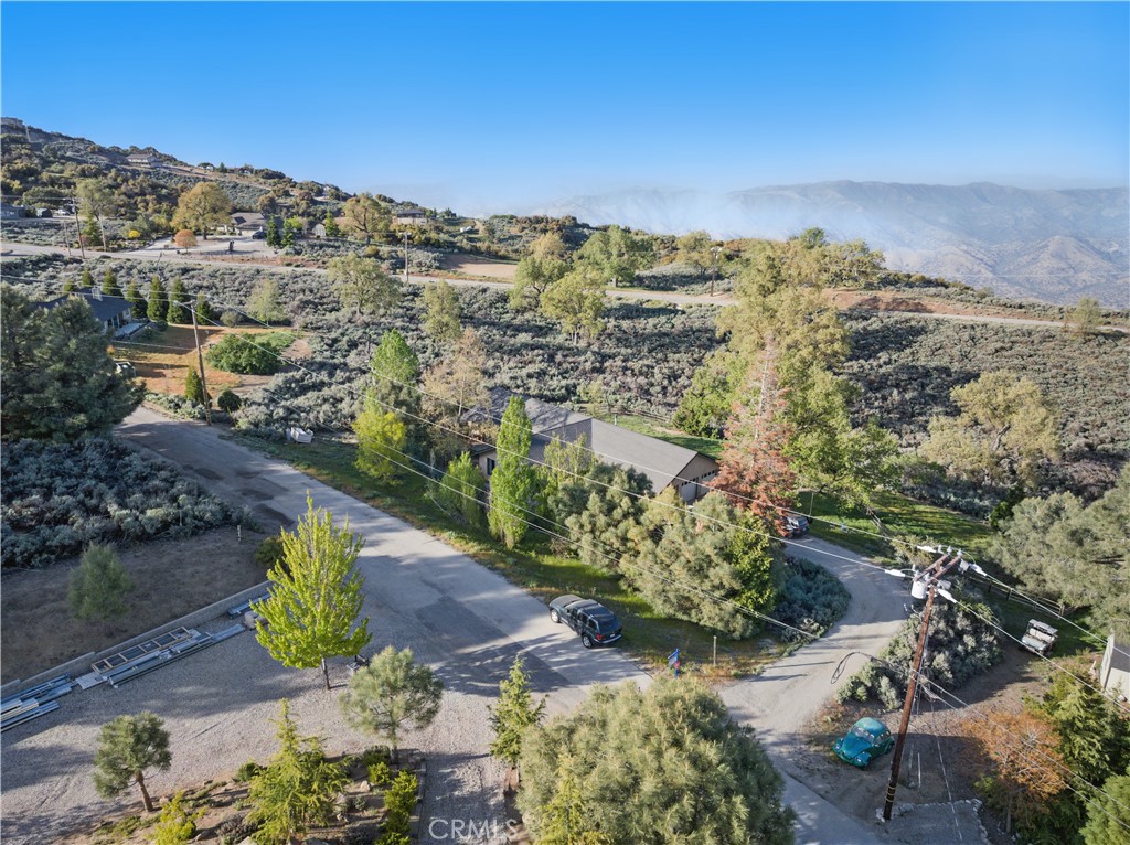 Price thousands below market value for quick sale and a possible Assumable 1st loan at approx. 2.75% buyer to verify. 4 bed 2.5 baths 2,441sf with a 3 car garage on a one acre fenced lot, nestled in this quiet Tehachapi community ofBear Valley Springs gated Community.oversized living room with vaulted ceilings, as you cross the hallway you enter a second living area with vaulted ceilings and a wood burning stove next to a large kitchen area with upgraded granite counters, black appliances, lots of wood cabinets also features a breakfast nook and a walk in pantry. Home also offers wide hallway, Master bathroom includes a separate walk in shower & large soaking tub and double sinks. Inside the 3 car garage hides the 1/2 bath. Enjoy this quiet horse property at a value price. Neighborhood amenities include Bear Valley Springs park, rec center, swimming pool, Tennis courts, trails, equestrian center dining options and more.
