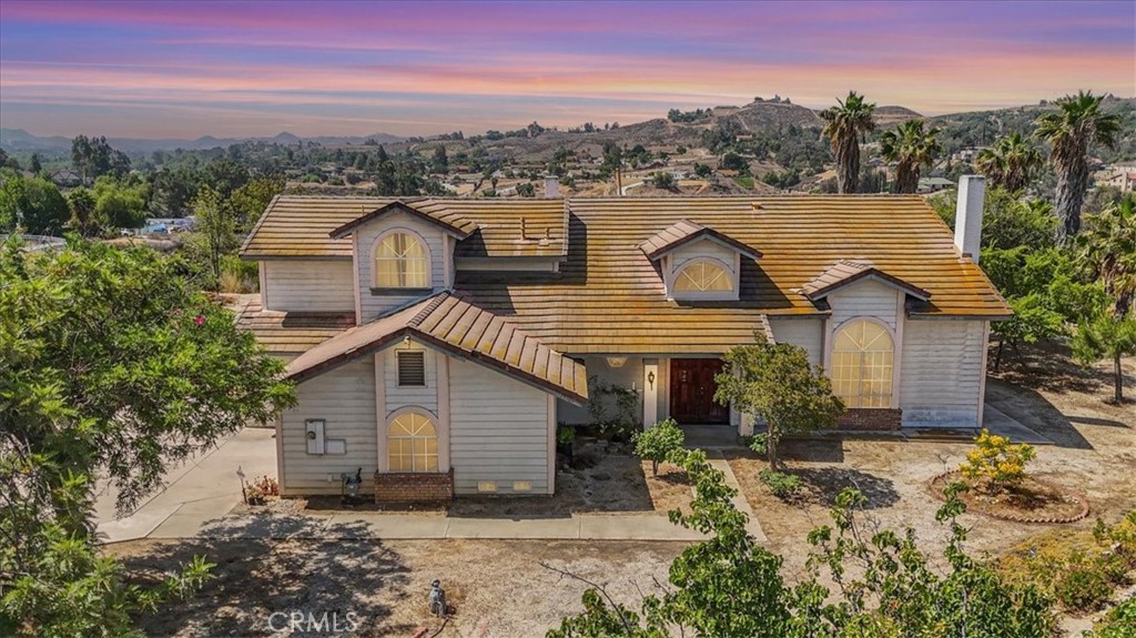 Enjoy breathtaking panoramic views of city lights and majestic mountains from this beautiful estate nestled on a peaceful cul-de-sac in the desirable Woodcrest neighborhood of Riverside.
This well-designed estate features 5 spacious bedrooms, 3 full bathrooms, and 3198 sf of living space. Situated on an expansive 40,075 sf lot. it also includes a 3-car garage(approx. 600 sf). It including a convenient downstairs bedroom and hallway full bath—perfect for guests or multigenerational living. Step through the elegant double-door entry into a grand foyer with soaring ceilings and a graceful wooden curved staircase.
The formal living room is filled with natural light and enhanced by vaulted ceilings and a charming brick fireplace. The floor plan flows beautifully into a formal dining room and an open-concept living area, perfect for entertaining.
The gourmet kitchen offers tile countertops, ample cabinetry, and a sunny breakfast nook, opening to a spacious family room with a cozy second fireplace. Modern and stylish durable vinyl plank flooring throughout the whole downstairs, adding fresh appeal to the main living spaces.
Upstairs, the primary suite is a peaceful retreat with a private balcony overlooking the backyard and mountain views. The ensuite bathroom includes a soaking tub, separate shower, and walk-in closet. The upstairs carpet may need updating, giving buyers the opportunity to customize flooring to their taste.
Step outside to an backyard with endless potential for outdoor living, gardening, or entertaining. The lot includes 13 mature fruit trees:
2 pear
1 peach
1 orange
1 grapefruit
1 pomegranate
5 loquat
The landscaping offers great opportunity for enhancement to your own oasis. The home itself is nice-maintained and need some upgrade. It offers a fantastic opportunity for buyer to upgrade and customize to their desire style. The home overall charm, structure, and exceptional view and huge lot make it rare to find. Spacious extended driveway perfect for RV or multiple vehicle parking.
Located near excellent schools, parks, shopping centers, and with easy freeway access, this home combines tranquility with convenience in one of Riverside’s most desirable neighborhoods.
Come see the potential, feel the charm, and imagine creating your dream home at 15705 Streamview Ct.!