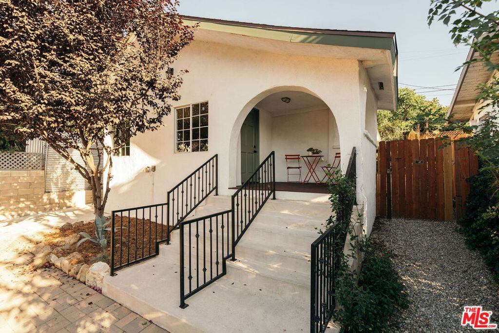 Nestled at the border of Cypress Park and Mt. Washington, 3356 Pepper Ave. is a rare jewel in the heart of Northeast Los Angeles -- a soulful 2-bed, 1-bath residence that strikes a perfect balance between vibrant city living and serene hillside escape. Past the striking arched entryway and romantic front porch, enter and find yourself in a home that evokes classic charm and modern sensibility. Newly installed oak floors welcome you into an open living/dining space with beautiful built-in shelving and large windows that bathe the home in golden hour sunlight. Enjoy meal prep in a kitchen that opens up to the living area and features newer appliances, quartz countertops, farmhouse sink, abundant cabinet space and a separate laundry area at the back. The outdoor space is a true showstopper: head out back and find your very own orchard -- 8 different fruit trees! -- as well as drought-tolerant landscaping, fire pit, new decomposed granite, garden shed, and sweeping views of the surrounding hills. Whether you dream of al fresco dinners under the stars, cultivating your own produce, or simply savoring morning coffee in a peaceful setting, the yard facilitates the best of outdoor living. A long driveway with parking spot leads to a separate detached structure in the back yard - great as a workshop or storage, or explore its potential as additional creative or office space. The home is as functional as it is lovely and features modern upgrades like a bolted foundation, central HVAC, solar panel system, and more. Perfectly positioned just moments from some of LA's most talked-about dining, shopping, hiking, and parks -- Barra Santos, Loquat, and Golden Poppy are within a half-mile -- the home delivers an unmatched balance between being in the heart of it all while feeling like you're miles away. 3356 Pepper Ave. is the rare gem that proves you don't have to sacrifice charm or location to secure your place in Northeast LA for under $1m - don't miss this exceptional opportunity where character, convenience, and tranquility come together to welcome you home.