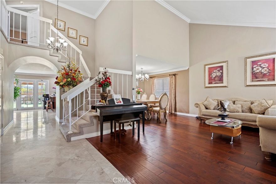 Nestled on a tranquil cul-de-sac of Anaheim Hills is this beautifully maintained 4 bedrooms, 3 bathrooms home offers nearly 3,000 square feet of living space on a spacious 6,800 square feet lot. Upon entering the home, you will be greeted with the formal living room setting the tone with rich engineering wood-color flooring that flows seamlessly into the charming formal dining room. At the back of the home, the expansive kitchen is designed with all amenities combined into the open family room good for both daily living and entertaining guests. The kitchen comes with adjacent wet bar, built-in nooks, granite countertops, large center island, stainless steel appliances, and 5-burner cook top. Recent upgrades completed in bathrooms include new vanity, marble flooring and wall. Home is equipped with smart switch electrical systems to facilitate on/off at ease plus a smart thermostat controlled temperature operation fan in the attic. Plus a plumbing leak detection system for entire home.  Additionally, home has a complete water softener system. A bonus interior laundry room. Plenty of natural sun lights to brighten this home.  Upstairs you will find a large primary suite with dual vanity and dual closets.  The oversized primary comes with seating retreat area for you to cozy up with a book or just relaxing to your TV programming.  The dual closet can be designated for his and hers.  Two additional bedrooms down the hallway as well as the extra-large 4th bedroom over the garage.  This extra-large bedroom could be used as a game, family, or entertainment room.  If you require additional bedrooms, this extra-large bedroom could be divided into 2 separate bedrooms. Stepping outside into your large, private backyard you will find a covered patio and plenty of greens. The home is complete with 3-car garage plus long driveway that could accommodate up to 4 cars. Plus a 220V 50A charger inside the garage. Finally, home is completed with security cameras with 6 channels.  You are just minutes from top-tier golf courses, shopping, all the best dining, and award-winning schools.