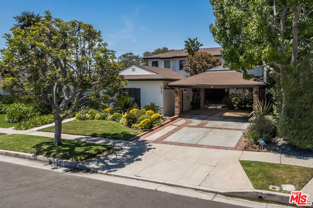 Welcome to this timeless 2-story Traditional residence in the heart of the coveted Castle Heights neighborhood. Sitting on a generous 7,600 sq ft flat lot, this spacious 3,200 sq ft home blends comfort, character, and classic California charm. Step through the inviting entry into a grand foyer that opens to expansive living spaces anchored by a cozy brick fireplace. Sliding glass doors lead to a bright sunroom and the backyard, creating a seamless indoor/outdoor flow. The formal dining room connects to a gourmet kitchen, thoughtfully designed with Sub-Zero refrigeration, Dacor double ovens with warming drawer, Corian countertops, custom cabinetry, built-in appliances, and a large center island perfect for both everyday living and entertaining. Upstairs, two generously sized bedrooms complement the luxurious primary suite, complete with dual vanities, spa-like soaking tub, glass-enclosed steam shower, custom storage, and his-and-her walk-in closets. A private balcony overlooks the landscaped backyard, where mature greenery surrounds a modern pool, hot tub, and trellis-covered patio--an ideal setting for al fresco dining and relaxation. Additional highlights include: Dedicated laundry room, Bonus game/rec room, Detached carport with EV charging, and Curated landscaping enhancing curb appeal. This rare offering combines a flexible floor plan with exceptional indoor-outdoor living, all within minutes of Culver City, Beverly Hills, and West L.A.