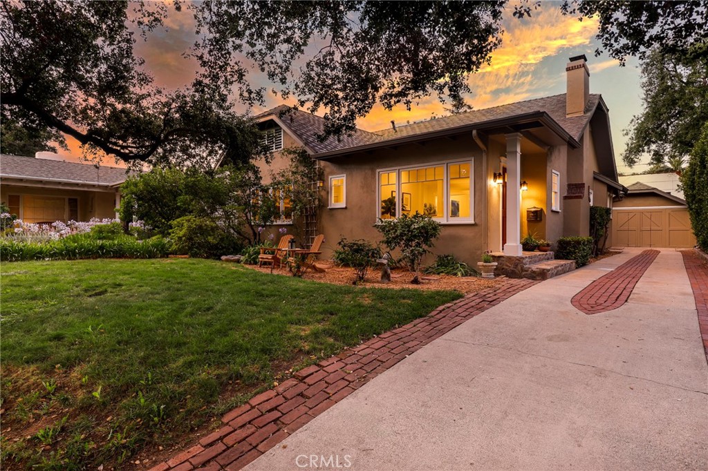 Nestled in the prestigious Arroyo, the heart of Southwest Pasadena, this charming 3-bedroom, 2-bathroom Traditional home with detached 2-car garage offers timeless character and modern comfort. Featuring an open floorplan drenched in natural light, the home seamlessly blends classic details with thoughtful design. As you enter the home, you are welcomed by a stunning Batchelder fireplace, built-in bookshelves, and rich hardwood floors. The spacious dining room opens directly to the backyard – ideal for indoor-outdoor entertaining.
The well-appointed galley kitchen includes granite countertops, double sinks, stainless steel appliances, and generous counter space for all your culinary needs. The serene primary suite boasts a luxurious en-suite bath, while two additional bedrooms share a stylishly updated bathroom. A private backyard offers an ideal setting for lively entertaining or peaceful morning coffee. A detached two-car garage adds convenience and extra storage.
Located in one of Pasadena’s most sought-after neighborhoods, this exceptional home offers close proximity to the Rose Bowl, award-winning private schools, fine dining, upscale boutique shopping, and the scenic trails of the Arroyo Seco. Don’t miss this opportunity!