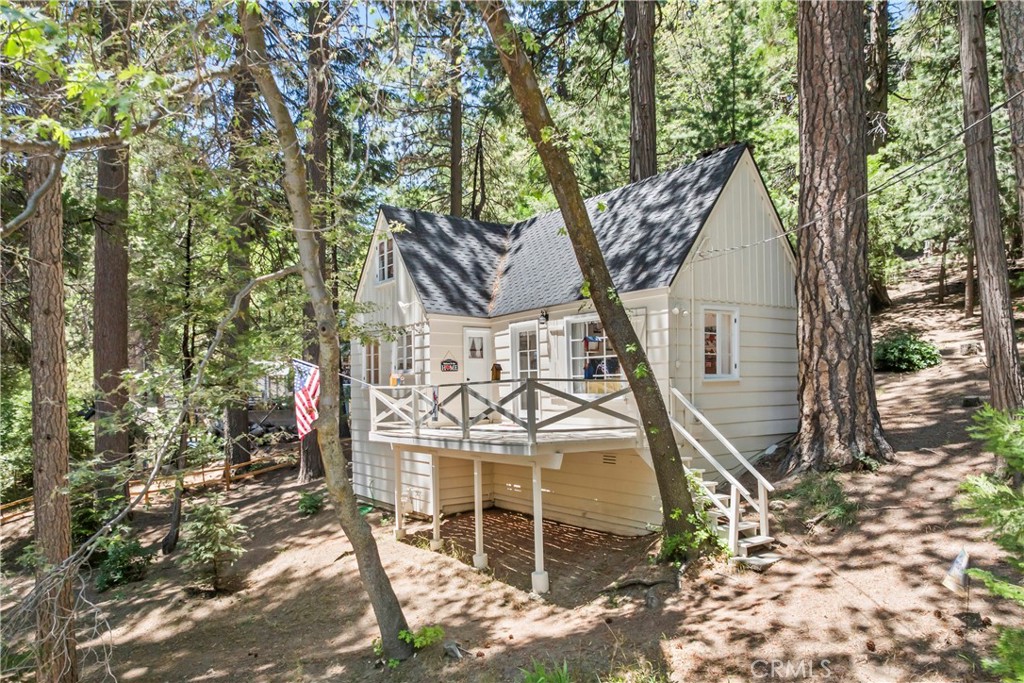 Classic 1938 Lake Arrowhead Charmer with Lake Rights.
Step into the timeless charm of this impeccably maintained 1938 Lake Arrowhead classic, located in a serene, park-like setting surrounded by towering trees and lush natural landscaping. With full lake rights and just a short stroll to the lake and Lake Arrowhead Village, this home offers the perfect balance of peaceful seclusion and walkable convenience.
Inside, you’ll find a light and bright dream kitchen that’s been beautifully updated while maintaining its vintage charm. Enjoy your morning coffee or casual meals in the cozy breakfast nook, a perfect spot to soak in the morning light and forest views.
This enchanting two-bedroom, two-bath home features vaulted ceilings throughout, creating an airy and open feel. The spacious upstairs suite offers a private retreat, while thoughtful updates like a whole house generator and a 50-year roof (installed just five years ago) provide peace of mind.
The home sits on a picturesque lot defined by split-rail fencing, with a paved parking area, generous storage, and mature trees that provide cool shade in the summer. The sunny exposure helps snow melt quickly in the winter—another reason this property is ideal for year-round enjoyment.
If you’re looking for an authentic Lake Arrowhead experience with the perfect mix of character, charm, and modern comforts, this is the one. Don’t miss your chance to own a true mountain gem.