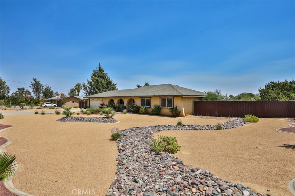 Welcome to 9021 11th Ave., Hesperia — a charming single-story pool home offering the perfect blend of comfort, function, and desert charm. Featuring 3 bedrooms, 2 bathrooms, and 1,374 sq. ft. of living space, this 1984-built residence is designed for easy living, all on one level. The two-car attached garage provides convenience, while the backyard’s sparkling pool invites you to unwind and enjoy sunny High Desert days.
What truly sets this property apart is its expansive 45,000 sq. ft. lot — offering endless possibilities. With the space and zoning Hesperia is known for, you could:
• Build a shop, RV garage, or additional storage buildings
• Park boats, RVs, trailers, or work trucks with ease
• Create a horse property or small hobby farm
• Install sports courts or a playground
• Develop an outdoor entertaining oasis with kitchens, seating areas, and gardens
• Explore ADU (Accessory Dwelling Unit) potential for multi-generational living or rental income (buyer to verify all above mentioned)
Step inside to find a well-planned layout with a comfortable living area, generous natural light, and spaces ready to be personalized to your style. The primary suite offers its own private bath, while two additional bedrooms create flexibility for guests, a home office, or hobbies.
Why Hesperia? This growing city is one of the High Desert’s most desirable destinations, known for its affordable housing, spacious lots, and small-town feel — all within reach of major commuting routes like the 15 Freeway. Nature lovers enjoy nearby Hesperia Lake Park, the Mojave River, and countless hiking, biking, and off-road trails. Families appreciate highly rated schools, community events, and the warm neighborhood atmosphere.
What’s up-and-coming? Hesperia continues to grow with new shopping centers, dining options, and entertainment venues. Planned city improvements and expanding retail hubs make it an excellent place to invest, while the arrival of new logistics and business parks brings fresh job opportunities and boosts the local economy. You’ll be close to everyday conveniences while still enjoying wide-open skies and peaceful surroundings.
Whether you’re relaxing poolside, hosting gatherings, or making full use of your land, this home offers the perfect starting point for your next chapter.