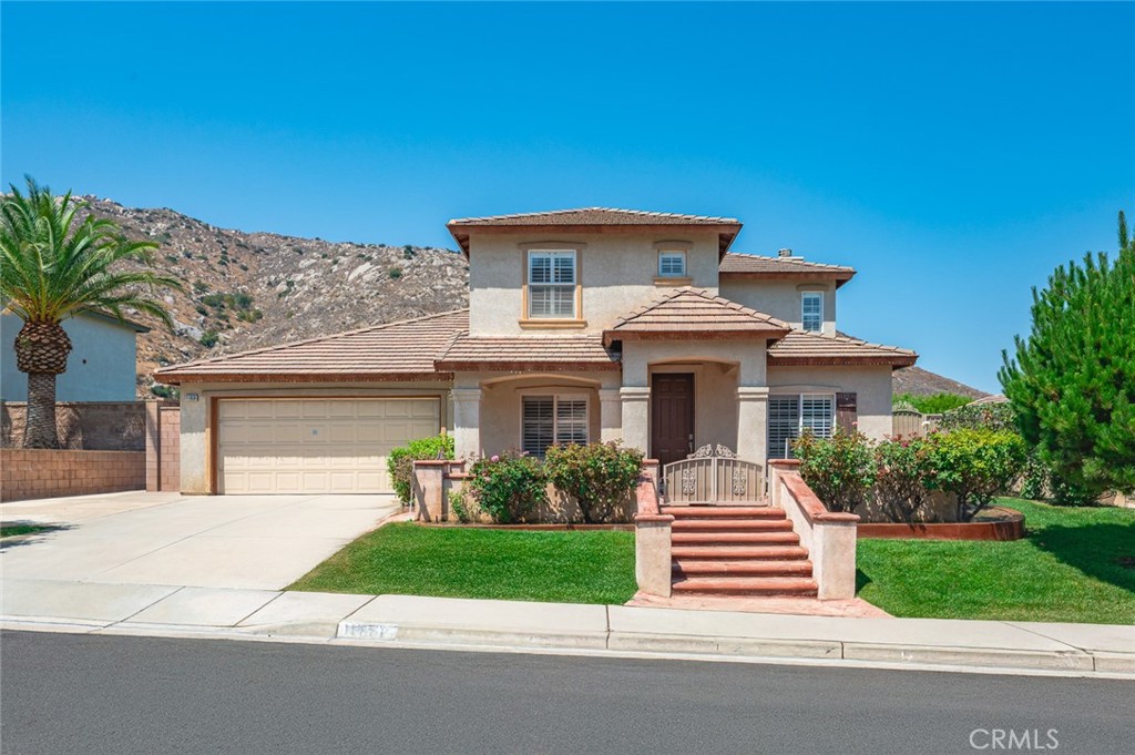 Welcome to 11658 Via Montana in the desirable community of South Park, Fontana! This spacious two-story home offers approximately 2,756 sq. ft. of comfortable living space, featuring 4 bedrooms and 3.5 bathrooms, including a convenient bedroom and full bath on the main floor.
Built in 1999, the home boasts a warm and inviting floor plan with wood floors, tile, and plush carpet in the bedrooms, plus plantation shutters throughout. The formal living and dining rooms create an elegant setting, while the additional library/piano/sitting room adds versatile space at the front of the home.
The heart of the home is the open-concept kitchen and family room, complete with a fireplace, granite countertops, beautiful light oak cabinetry, and plenty of counter space. A large laundry room with pantry shelving, abundant cabinetry, and a built-in desk area offers practicality and storage.
Upstairs, you'll find spacious bedrooms and a well-designed layout for privacy and comfort. The exterior is just as inviting, with a charming Spanish-style front porch, covered backyard patio, fruit trees, and a fully fenced yard—perfect for relaxing or entertaining.
Additional features include an attached two-car garage and prime location close to schools, shopping, and major freeways.