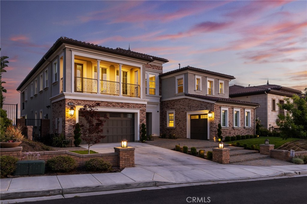 Huge Price Reduction!! Introducing 19818 Cornell Lane—an extraordinary Toll Brothers home nestled in one of Yorba Linda’s most coveted gated communities. Perfectly situated on one of the few premium lots with rare, unobstructed views, this residence offers a unique blend of elegance, privacy, and everyday convenience—just a short walk to the award-winning Yorba Linda High School.
South-facing with dual balconies and soaring entry ceilings, the home is drenched in natural light from sunrise to sunset. Its thoughtfully designed open floor plan features spacious living areas, upgraded finishes, and a seamless indoor-outdoor connection. The grand primary suite boasts stunning views and a custom walk-in closet that’s as luxurious as it is functional.
Step into the meticulously curated backyard—an architectural gem in itself. Inspired by minimalist garden design, it features a striking water element: a designer-crafted stream that flows gently like a sculptural fountain, creating a serene, river-like ambiance. Surrounded by bamboo and perfectly manicured landscaping, this outdoor space offers both tranquility and visual drama rarely found in the community.
With sunset views, resort-style finishes, and a rare view-facing premium lot inside a secure gated neighborhood, this home is truly a standout. Moments from top schools, shopping, dining, and parks—it’s a lifestyle home you won’t want to miss.