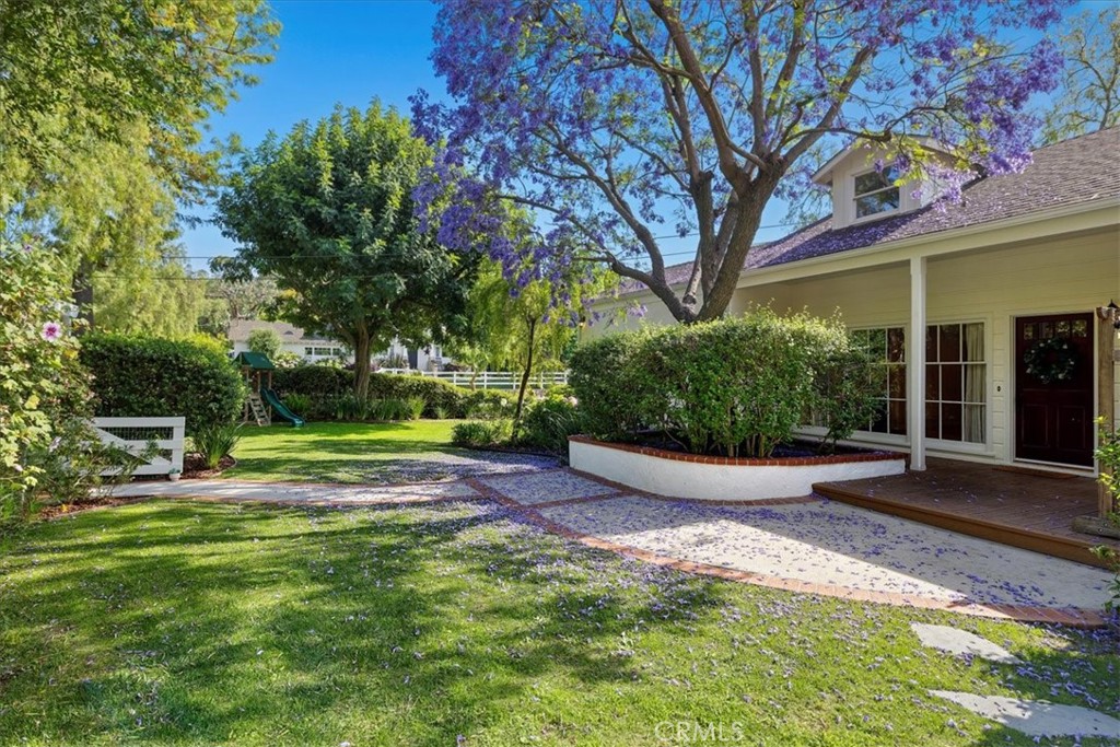 Nestled in the highly sought-after Dapplegray neighborhood known as "The Lanes", this charming home is flooded in natural light and features beautiful newly refinished hardwood floors that flow seamlessly throughout. The spacious living room opens to an upgraded kitchen with stainless steel appliances and granite countertops with bar-top seating on each side. The dining area blends the kitchen and the outdoor living space perfectly. The backyard is an entertainer's dream. A large pergola includes a TV, speakers, lighting and fans provide a cool shaded area for the summer and electric heaters for the cooler evenings. The wet bar, equipped with refrigerator drawers, an ice machine, and a long buffet counter, is ideal for outdoor dining or entertainment. This outdoor oasis also includes a hot tub that flows into a sparkling saltwater pool with water features, a mini putting green, a fire pit and a large grassy yard. The property is surrounded by lush greenery, ensuring optimal privacy. The large primary bedroom boasts cathedral ceilings, a walk-in closet, carpeted floors, and an updated bathroom. There are two other generously sized bedrooms and a full bathroom with a jetted bathtub. While tax records indicate four bedrooms, one room has been opened up and converted into additional living space. Upstairs you’ll find a bonus bedroom and a three-quarter bathroom which gives you approximately an additional 625 sqft. Situated on a gated corner lot, this home also features forced air heating and A/C, recessed lighting, vaulted ceilings, skylights, a fireplace, dual water heaters, a heated pool, and ample storage throughout.