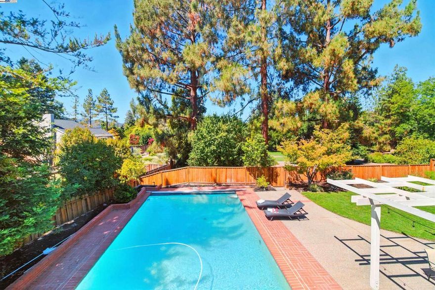 Situated in Walnut Creek’s highly sought-after Rudgear Meadows community, right on the border of Alamo, this beautifully remodeled gem offers the perfect blend of style, comfort, and location. Features 5 spacious bedrooms plus a versatile downstairs bonus room, ideal for a home office or an additional bedroom,2.5 baths, and 2,604 sqft of open-concept living, this home sits on a private lot with a sparkling pool, generous patio space for dining, a grassy play area, and direct access to a hidden park and community greenbelt. Step inside to a freshly painted interior, brand-new carpet, and a bright, airy floor plan. The chef’s kitchen is a true showpiece, boasting granite countertops, stainless steel appliances, a large center island, and newly painted cabinets. Additional features include a whole-house fan for quick, energy-efficient cooling, Nest thermostat, electric safety pool cover, and garage built-in cabinetry with a mudroom/work station. Enjoy your own backyard oasis — perfect for relaxing after work or a day of remote learning — or take advantage of nearby hiking and biking trails. Ideally located just minutes from Round Hill Country Club, top-rated San Ramon Valley schools, parks, restaurants, shopping, and commute routes. This is your lifestyle upgrade !