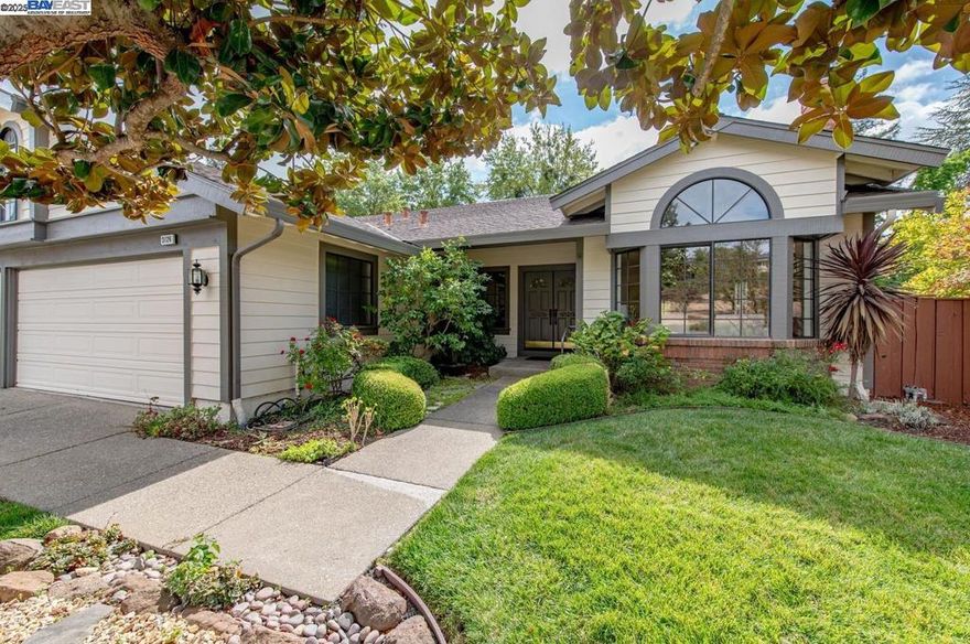 This spacious single-story home in the desirable Vintage Hills II neighborhood offers owned solar and fresh updates including new interior paint, flooring, and lighting. A welcoming front yard with blooming hydrangeas leads to a charming covered porch. Inside, the formal living room features vaulted ceilings and a fireplace, flowing into a dedicated dining area. The kitchen is filled with natural light from skylights and includes black appliances, a walk-in pantry, and a breakfast nook with a window seat. The adjacent family room offers vaulted ceilings, a second fireplace, and access to the backyard for seamless indoor-outdoor living. The primary suite includes backyard access, a walk-in closet, and a spacious bath with dual vanities and a large walk-in shower. Two additional bedrooms—one with en suite access to the hall bath—offer flexibility for guests or a home office. The backyard features award-winning roses, two gazebos (one wired for a spa), and raised garden beds. Three-car garage with built-ins. Low HOA with community pool. Convenient to parks, top-rated Pleasanton schools, downtown, ACE Train, and commuter access. Open House Sat & Sun, Oct 11-12 1-4p.