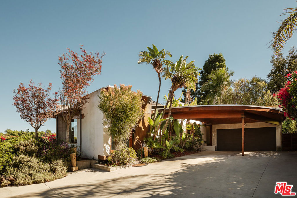 Rarely does an architectural showpiece like the Glenridge House come to market. Built in 1965, 3604 Glenridge Drive stands as a shining example of mid-century residential design, thoughtfully reimagined for modern living. Privately set behind gates at the end of a long, secluded driveway, this extraordinary single story property rests on an expansive 10,310-square-foot lot surrounded by nature. Featuring 4 bedrooms and 3 bathrooms, capturing breathtaking mountain, valley, and city lights views, the home reflects Webb's timeless architectural sensibility, clean lines, natural materials, and an effortless indoor/outdoor flow. A bright, open floor plan centers around a spacious living room with wood-beamed vaulted ceilings, a floor-to-ceiling stone fireplace, a mix of concrete and bamboo floors, and walls of glass that open to an expansive viewing deck. The sleek kitchen blends form and function with European-style cabinetry, honed black granite counters, stainless steel appliances, and dual breakfast bars. It opens to a large family room with French doors leading to a flat, grassy private backyard, perfect for entertaining or quiet relaxation. The renovated primary suite opens directly to the viewing deck, offering panoramic vistas. Its luxurious bath features a soaking tub with views, dual granite vanity, and a frameless glass shower. Spacious secondary bedrooms include vaulted ceilings and abundant natural light. Additional upgrades include HVAC system, plumbing, roof, and glass deck railings. Surrounded by nature and architectural heritage, 3604 Glenridge Drive is more than a home, it's an architectural statement, celebrating mid-century design through a contemporary lens.