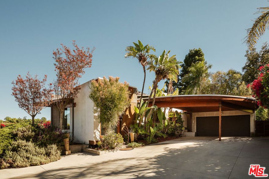 Rarely does an architectural showpiece like the Glenridge House come to market. Built in 1965, 3604 Glenridge Drive stands as a shining example of mid-century residential design, thoughtfully reimagined for modern living. Privately set behind gates at the end of a long, secluded driveway, this extraordinary single story property rests on an expansive 10,310-square-foot lot surrounded by nature. Featuring 4 bedrooms and 3 bathrooms, capturing breathtaking mountain, valley, and city lights views, the home reflects Webb's timeless architectural sensibility, clean lines, natural materials, and an effortless indoor/outdoor flow. A bright, open floor plan centers around a spacious living room with wood-beamed vaulted ceilings, a floor-to-ceiling stone fireplace, a mix of concrete and bamboo floors, and walls of glass that open to an expansive viewing deck. The sleek kitchen blends form and function with European-style cabinetry, honed black granite counters, stainless steel appliances, and dual breakfast bars. It opens to a large family room with French doors leading to a flat, grassy private backyard, perfect for entertaining or quiet relaxation. The renovated primary suite opens directly to the viewing deck, offering panoramic vistas. Its luxurious bath features a soaking tub with views, dual granite vanity, and a frameless glass shower. Spacious secondary bedrooms include vaulted ceilings and abundant natural light. Additional upgrades include HVAC system, plumbing, roof, and glass deck railings. Surrounded by nature and architectural heritage, 3604 Glenridge Drive is more than a home, it's an architectural statement, celebrating mid-century design through a contemporary lens.