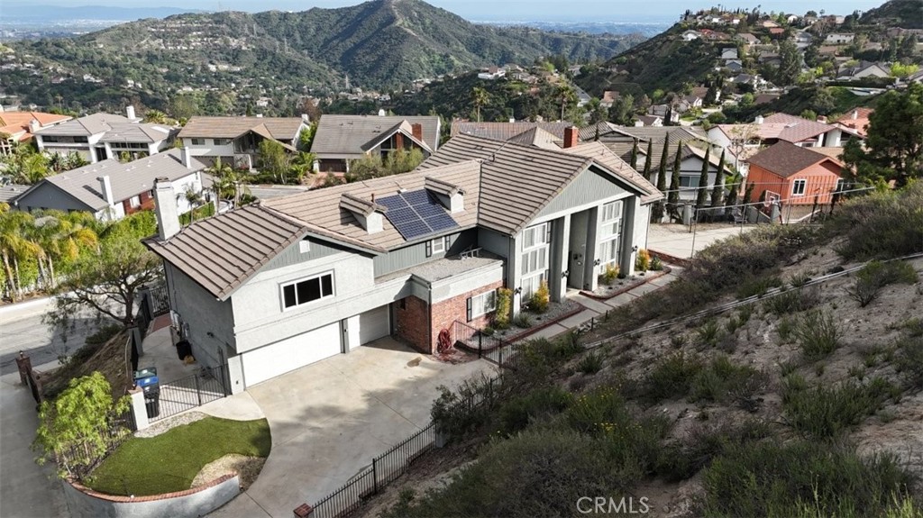 Situated in the prestigious Emerald Isle neighborhood of Glendale, this beautifully designed 5-bedroom, 5-bathroom residence offers privacy, elegance, and exceptional comfort. Set behind a gated entrance with a private driveway, the home welcomes you with a dramatic entryway featuring soaring ceilings and a sweeping circular staircase.
The main level offers two bedrooms, including a spacious guest suite with its own private bathroom—ideal for extended family or visitors. The formal dining room and stylish powder room provide the perfect setting for entertaining, while the expansive family room with high ceilings and a cozy fireplace creates a warm and inviting atmosphere.
The kitchen is thoughtfully designed with ample cabinetry, a center island, and newer stainless steel appliances—perfect for everyday meals or hosting on a larger scale. A separate laundry room adds convenience to the functional layout.
Upstairs, you’ll find three additional bedrooms. Two secondary bedrooms share a well-appointed hallway bathroom with dual sinks, while the luxurious primary suite is a true retreat. Enjoy breathtaking views of downtown Glendale, his-and-hers closets with generous storage, and a spa-like master bath featuring a whirlpool tub, a separate stall shower, and dual vanities.
The outdoor amenities elevate the experience even further, with a dedicated sports court, a charming trellis-covered patio space for outdoor dining or lounging, and energy-efficient solar panels. The fully gated lot offers privacy, security, and a sense of exclusivity.
This is a rare opportunity to rent a thoughtfully designed and meticulously maintained home in one of Glendale’s most coveted enclaves.