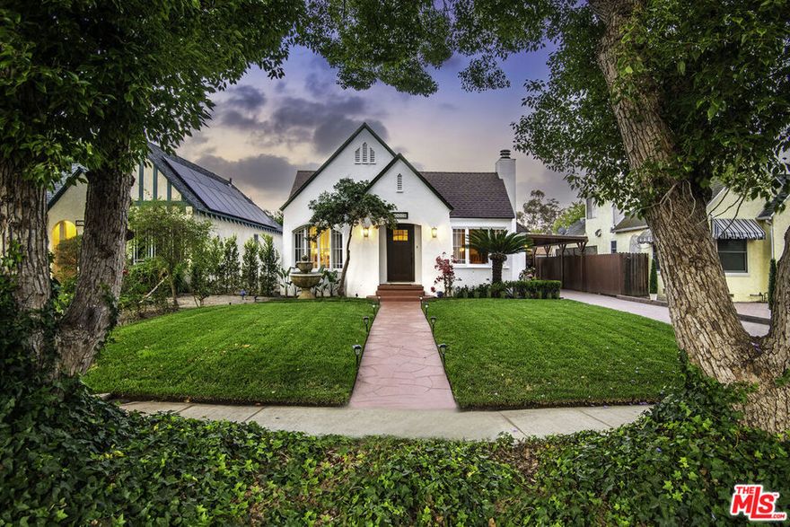Beautifully remodeled c.1926 Tudor-style cottage nestled in the heart of Toluca Lake. 3 + 2 plus 1 + 1 guesthouse. Original details have been lovingly preserved incl. graceful arches, latch windows, built-ins, Red Oak flooring and high ceilings. Fireside living room and bright open dining room with crown molding and French doors flow to spacious cov'd brick patio--perfect when you want to move the entertaining outdoors! Modern kitchen with sophisticated muted palette, quartz tops, open shelving, gorgeous tile backsplashes and floor, refurbished vintage stove, farm sink, dining area, pantry and laundry. Main suite incl. upgraded bathroom, walk-in closet and access to patio. Bonus unfinished flex space above garage! Private entrance and separate covered patio for 634 sq. ft. guesthouse complete with carriage house doors, full kitchen, dining area, living room, and garage W/D. Brick drive to carport; approx. 7K sq. ft. lot.