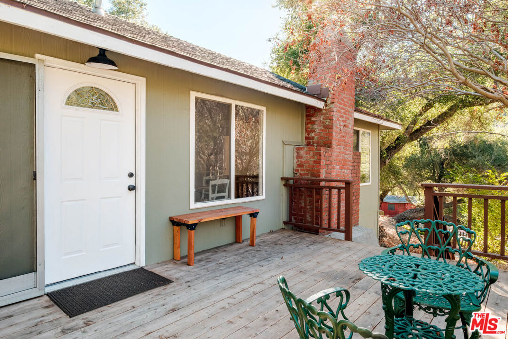 Located on a vibrant acre of land with fruit trees, hillside views, this thoughtfully updated home offers comfort, style, and functionality. Featuring two spacious bedrooms filled with natural light, the home creates a calm and airy atmosphere ideal for both relaxation and productivity. The open-concept layout seamlessly connects the living, dining, and kitchen areas, making it perfect for entertaining or everyday living. A cozy wood-burning fireplace adds warmth and character, while brand-new windows showcase scenic views and enhance energy efficiency. Recently installed central air conditioning and heat ensures year-round comfort. The freshly painted interior and beautifully refinished hardwood floors bring a clean, timeless look throughout. The kitchen is equipped with, high-quality appliances that make daily routines effortless. Outdoors, the fenced front yard offers added privacy space for pets, gardening, or quiet mornings. A private storage shed provides additional room for tools and seasonal items. With a location that is both private and central, this home combines convenience with a sense of retreat. Whether you're starting your day with coffee on the porch or winding down by the fireplace, this well-maintained property offers the ideal setting to call home.