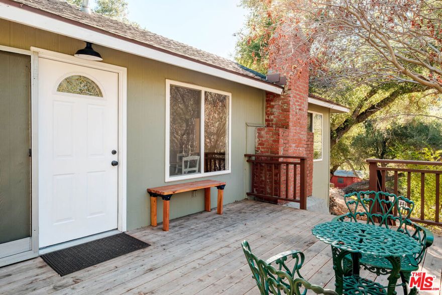 Located on a vibrant acre of land with fruit trees, hillside views, this thoughtfully updated home offers comfort, style, and functionality. Featuring two spacious bedrooms filled with natural light, the home creates a calm and airy atmosphere ideal for both relaxation and productivity. The open-concept layout seamlessly connects the living, dining, and kitchen areas, making it perfect for entertaining or everyday living. A cozy wood-burning fireplace adds warmth and character, while brand-new windows showcase scenic views and enhance energy efficiency. Recently installed central air conditioning and heat ensures year-round comfort. The freshly painted interior and beautifully refinished hardwood floors bring a clean, timeless look throughout. The kitchen is equipped with, high-quality appliances that make daily routines effortless. Outdoors, the fenced front yard offers added privacy space for pets, gardening, or quiet mornings. A private storage shed provides additional room for tools and seasonal items. With a location that is both private and central, this home combines convenience with a sense of retreat. Whether you're starting your day with coffee on the porch or winding down by the fireplace, this well-maintained property offers the ideal setting to call home.