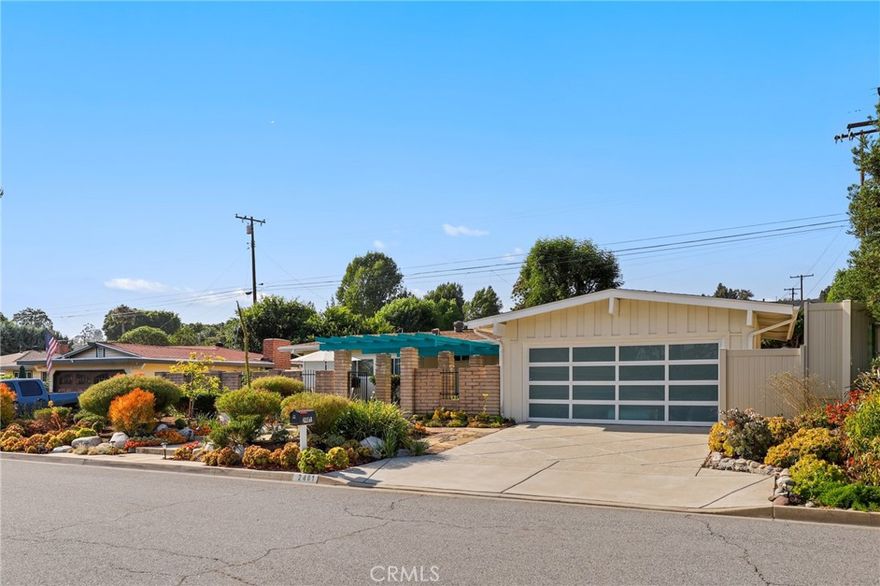 Stylishly Renovated Mid-Century Modern Gem in La Habra! Welcome to 2401 Canfield Drive, where mid-century charm meets modern sophistication in one of La Habra’s most sought-after neighborhoods—nestled above Whittier Blvd near the foothills of La Habra Heights. Surrounded by quiet streets and long-time residents, this beautifully updated home offers both style and serenity. Step inside to an airy open-concept layout featuring vaulted ceilings and abundant natural light. The brand new kitchen is a showstopper, complete with gray shaker soft-close cabinetry, a striking waterfall-edge quartz island, new stainless steel appliances, and a statement copper sink—perfect for both everyday living and entertaining. New luxury vinyl plank flooring flows seamlessly throughout the home, accented by plantation shutters, upgraded light fixtures, and a custom gas fireplace that anchors the living space. The primary bedroom includes an ensuite bathroom with oversized walk-in shower, while the versatile fourth bedroom opens to the living room—ideal for a home office or den. One of the secondary bedrooms offers direct access to the backyard through a sliding glass door. Additional upgrades include new bathroom vanities, new heating and air conditioning system, updated plumbing, a tankless water heater, new electrical panel, new garage door, and a freshly epoxied garage floor. Outside, enjoy lush, mature landscaping in both the front, entry courtyard, and private backyard—a perfect place to relax or entertain. Plus, there is potential for a two-story ADU in the back!  This home is conveniently located near award-winning schools like Macy Elementary and just minutes from Hacienda Park, where you can enjoy summer concerts and community events. Don’t miss your chance to own this rare blend of design, comfort, and location in a truly special La Habra neighborhood.