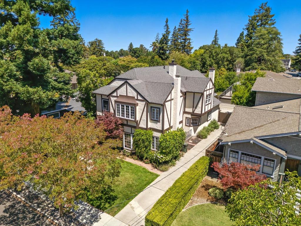 Situated on a tree-lined street in the prestigious Edgewood Park neighborhood, this stately 4-bedroom, 4-bathroom home offers timeless charm, thoughtful updates, and a fantastic layout for everyday living and entertaining alike. A formal entry welcomes you into a spacious living room with hardwood floors, beautiful custom molding, and a classic brick fireplace framed by picture windows. Just beyond is the formal dining room. The chef's kitchen opens to a generous family room with direct access to a large deck and lush backyard, perfect for outdoor dining or play. An en-suite bedroom on the entry level provides a private retreat for guests or extended family, while a full hall bath and laundry room add extra convenience. Upstairs, the grand primary suite features a cozy fireplace, private balcony, and an adjoining flex spaceideal for a home office, nursery, or reading nook. Two additional bedrooms share a full bath and offer plenty of space to spread out. Blending original character with modern amenities, this home is just minutes to vibrant downtown Redwood City and San Carlos shops, dining, and transit. A rare opportunity in one of the Peninsulas most desirable neighborhoods.