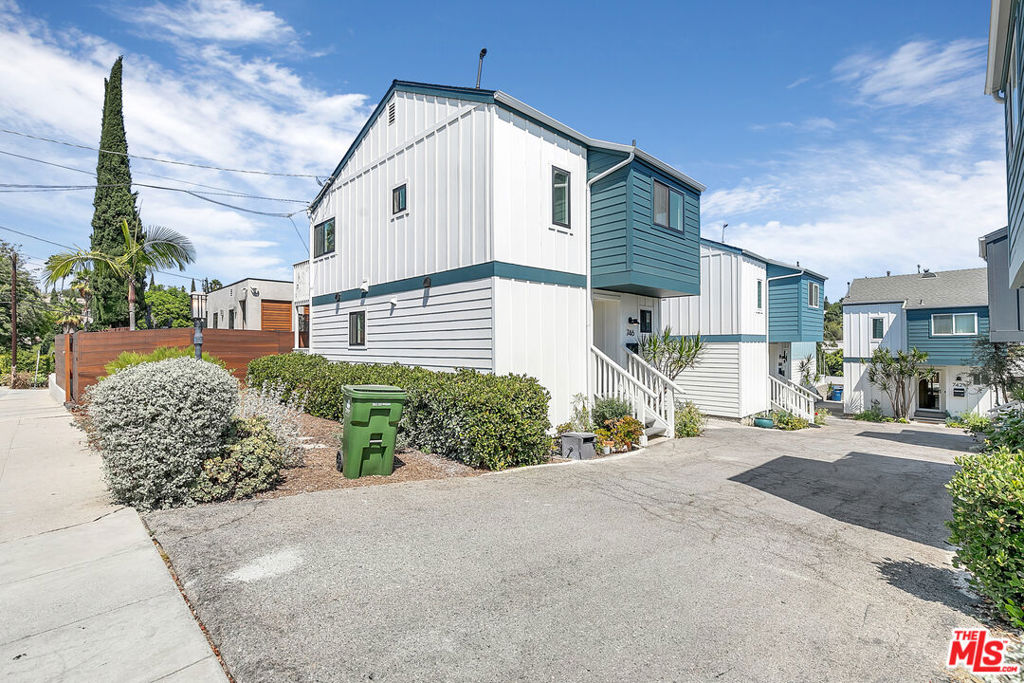 Discover this charming 3-bedroom, 2-bath standalone home in the heart of Silver Lake. With a distinct East Coast flair to its exterior, this fully detached residence delivers privacy, charming details, and all the necessities you need, plus side-by-side parking for two in your own driveway. Step inside to a bright living area that feels instantly welcoming. Just off the entrance, you will find a brand-new full bathroom for added convenience. Continue into the kitchen, where a crisp, modern aesthetic meets functionality, complete with a gas range stovetop with interchangeable grill tops, oven, dishwasher, microwave, and refrigerator. A hall closet adds extra storage, and the stacked washer/dryer is conveniently located nearby. From the living space, patio doors open to your private fenced outdoor area, perfect for entertaining, growing herbs in the planter boxes, or setting up a cozy lounge. Upstairs, you will find three inviting bedrooms. The largest bedroom boasts a vaulted ceiling, an extra-long closet, and a ceiling fan. One of the two additional bedrooms offers direct access to the outdoor space, while both feature mirrored closets, serene views of the Silver Lake hills, and fresh new flooring. A second full bath has been updated with a sleek vanity and shower/tub combo to complete the upper level. With central AC and heat, comfort is yours year-round. This one checks all the boxes! Don't miss out on this Silver Lake gem!