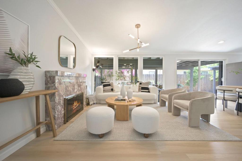 Welcome to 1114 Lily Avenue, a fully remodeled, move-in-ready home tucked away in Sunnyvale's sought-after Ponderosa Park neighborhood. A fresh exterior, custom front door, and mature garden set a welcoming tone for the thoughtful design inside. Renovated in 2024 with a newer 5-year-old roof, every detail was crafted with style and quality. Inside, the open layout is filled with light and features vaulted ceilings, wide-plank floors, and upscale finishes. The living space connects to a chef's kitchen with quartz counters, custom cabinetry, a full backsplash, and stainless-steel appliances. Bathrooms shine with German-engineered fixtures and sleek tilework. The oversized primary suite offers yard access, a custom walk-in closet, and a modern en-suite with a walk-in shower. A second oversized bedroom also features soaring ceilings, a large closet, and private yard access. The landscaped yard boasts a covered deck, flowering plants, and fruit trees. A private bonus suite with its own entrance, kitchenette, full bath, and laundry adds versatility. Notable upgrades include dual-pane windows, mini-splits, a tankless water heater, and more throughout. Close to parks, top schools, Apple, and Nvidia, this home blends modern comfort, outdoor charm, and Silicon Valley living at its best!