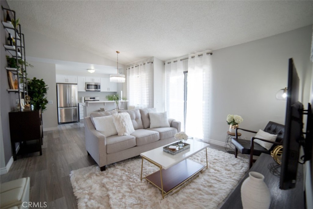 Upgraded 2-bedroom, 2-bathroom condo located on the second floor, featuring central air and heating, a stainless steel stove, modern flooring, and a private balcony. This unit includes in-unit laundry hookups as well as access to community laundry facilities. There are also 2 assigned tandem parking spaces available in a gated carport. Water and trash services are included. The community offers a play area and a basketball court.