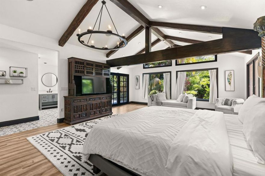 Welcome to your own tropical retreat, perfectly situated on over half an acre at the meeting point of Rancho Santa Fe, Encinitas, and Olivenhain. This gated estate offers the peace and privacy of a secluded getaway while keeping you close to upscale dining, boutique shopping, and the coast. Designed for effortless California living, every space has been created to blend comfort, functionality, and style. The expansive primary suite feels like a private resort with sweeping tree-lined views, a newly remodeled spa-inspired bathroom, and a spacious walk-in closet that connects directly to the upstairs laundry. Whether you want to unwind or work from home, a detached ADU office just steps away offers convenience without sacrificing connection. Outdoor living centers around the Pebble Tek pool and spa, which can be controlled from your phone. Host gatherings by the fire pit and outdoor dining area with built-in heat, or enjoy the multi-sport court for pickleball, golf, or soccer. The grounds have been redesigned with new concrete surfacing and lush, Spanish-inspired landscaping for beauty and ease of maintenance. Recent updates throughout the home include solar panels, a tankless water heater, EV charger, upgraded roof underlayment, fresh paint, an enhanced septic system, and a transformed theater with bar and LED fireplace. Smart home features add security and control at your fingertips. Every upgrade here brings comfort, efficiency, and peace of mind, giving you a lifestyle that’s both elevated and effortless. This home isn’t just a sanctuary, it’s a statement of living well.