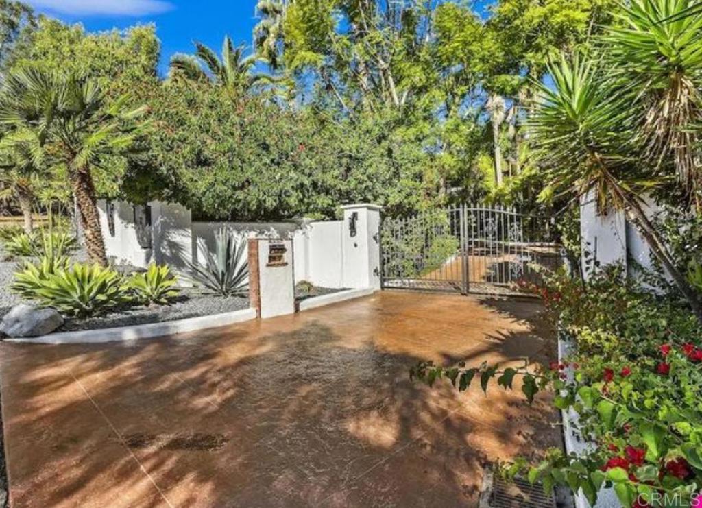 Welcome to your private tropical paradise, a rare estate resting on more than half an acre at the crossroads of Rancho Santa Fe, Encinitas, and Olivenhain. This gated retreat delivers unmatched privacy and tranquility while still placing you minutes from world class shopping, pristine beaches, and quick freeway access. Every improvement here was made with purpose. The kitchen was redesigned for both flow and function with new countertops, cabinetry, sink, and dishwasher. A larger pantry was created, the fridge relocated, the ceiling raised with an exposed beam, and lighting arranged to open the space. Fireplaces in both living rooms were upgraded, non structural walls adjusted, and bedrooms expanded with larger closets and improved access. The primary suite now features a completely remodeled spa bath along with a spacious closet connected directly to the new upstairs laundry. The estate invites California living at its best. A freshly refinished Pebbletek pool and spa form the centerpiece of the grounds, now controlled with ease from your smartphone. Entertain around the new fire pit, outdoor barbecue, and pergola, or enjoy the sports court designed for pickleball, soccer, golf, and more. The pool area has been resurfaced with new concrete for safety and style, while months of thoughtful landscaping have created a modern Spanish setting accented with stonework and agave plants. Practical upgrades bring peace of mind. A new roof, fresh paint inside and out, updated septic system with seepage pit, solar panels, tankless water heater, and EV charger support both comfort and efficiency. The theater room has been transformed with new drywall, bar, lighting, and an LED fireplace. Security features include cameras inside and out, a video doorbell, smart thermostat, automated locks, and an advanced Go go Gate that allows full control of entry from anywhere. This home is not only a sanctuary. It is leverage. It gives you a lifestyle where design, technology, and function align so nothing is left on the table. For the buyer who values both elegance and ease, this property is an opportunity that will be difficult to replace.