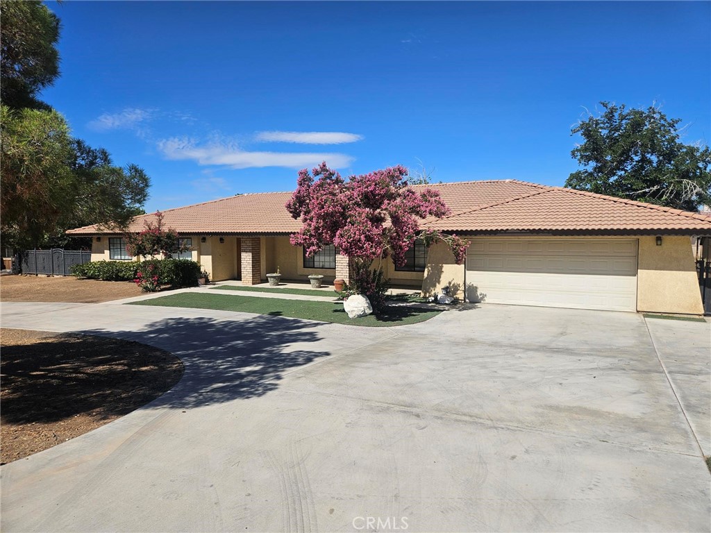Currently Tenant Occupied. For a big or growing family, this single-family home, built in 1985, is beautifully designed for comfort living. On a ±0.63 AC lot and located in a quiet, yet in-demand community of Apple Valley, CA, this single family residence has an amazing open layout. A total of ±3,162 SF, the main home is ±2,449 SF with an additional 713 SF bonus build-out with an additional bath and living area. A very large Master Bedroom includes his and her closets, large bathroom and great lighting with a back door to the large covered back patio and backyard that includes a shed. 3 additional bedrooms are on the same side as the Master along with 1 full hall bath and one half bath. Additional features include ornate details including lots of cabinet and built-in shelving, tray ceilings with fans, double door front entry, modern fixtures and upgrades throughout. Floor plan includes living, dining, and family areas that all connect around each other. The open kitchen is a great size with stainless steel appliances, pantry, breakfast nook and more. Behind the 2-car garage is another enclosed area that has been converted over time to additional living quarters with a bathroom and kitchenette area (some finish work is required on this area and details are to be confirmed). A half-circle driveway allows easy access from the street and past the double entry wrought-iron gate that fronts the entirety of the home with small entry gate door. Fully-paid solar gives cost savings for the electric bill for the next owner. Electric car Tesla charger also installed. Nearby conveniences include schools, shopping, retail, and centralized to neighboring cities of Victorville and Hesperia. Not far from the I-15 freeway, backroads to Lucerne Valley, Big Bear, and more. Take a look today at this home that will be something very unique that the next family can really use or continue to keep it tenant-occupied as a great investment. Enjoy and appreciate all that it offers. Buyer to confirm and verify all.